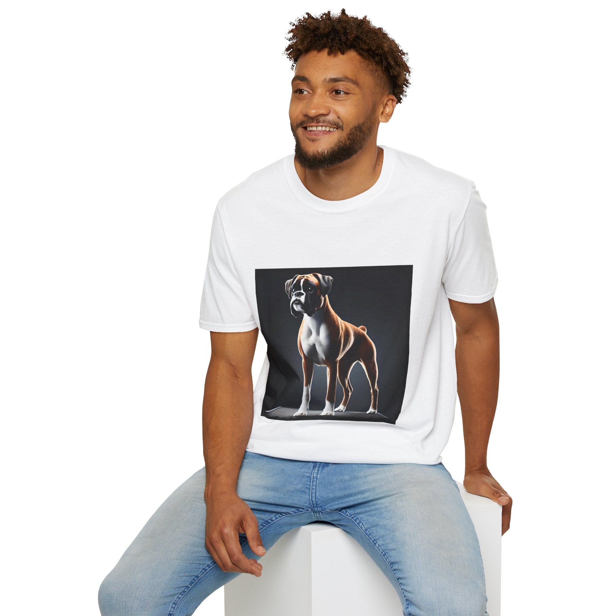 Male model in white dog t-shirt featuring standing boxer on platform with black background and dramatic lighting.
