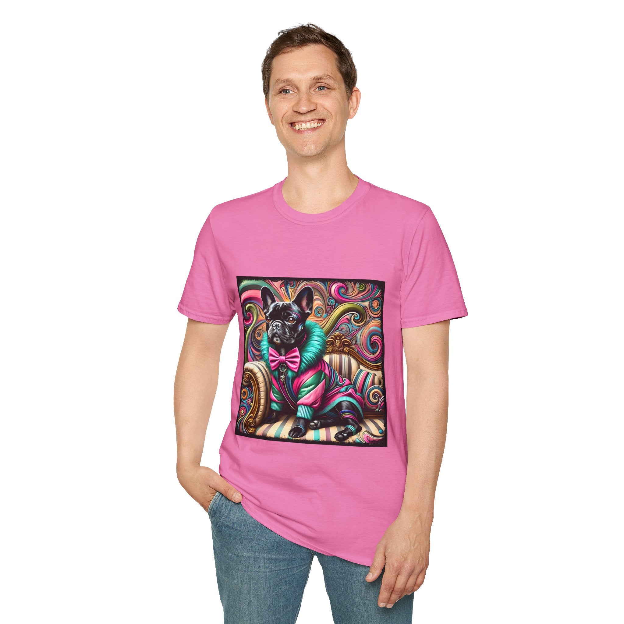 Man smiling in dark pink dog t-shirt with black French Bulldog in pink and teal outfit on swirl background and settee.