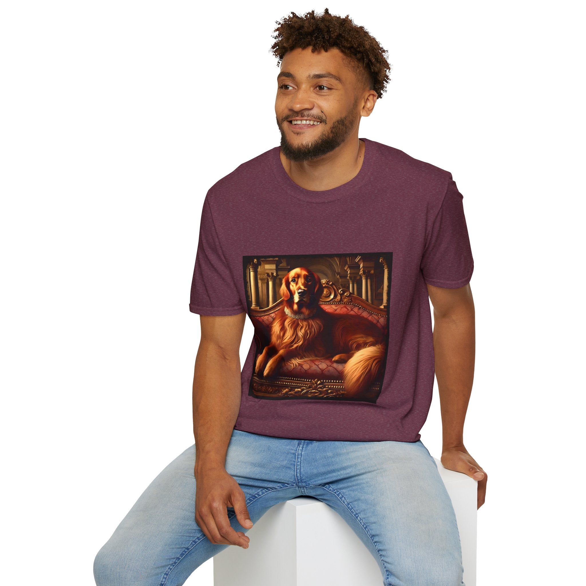 Male model in heather maroon dog t-shirt with golden retriever on red settee, pearl collar, and regal columned backdrop.