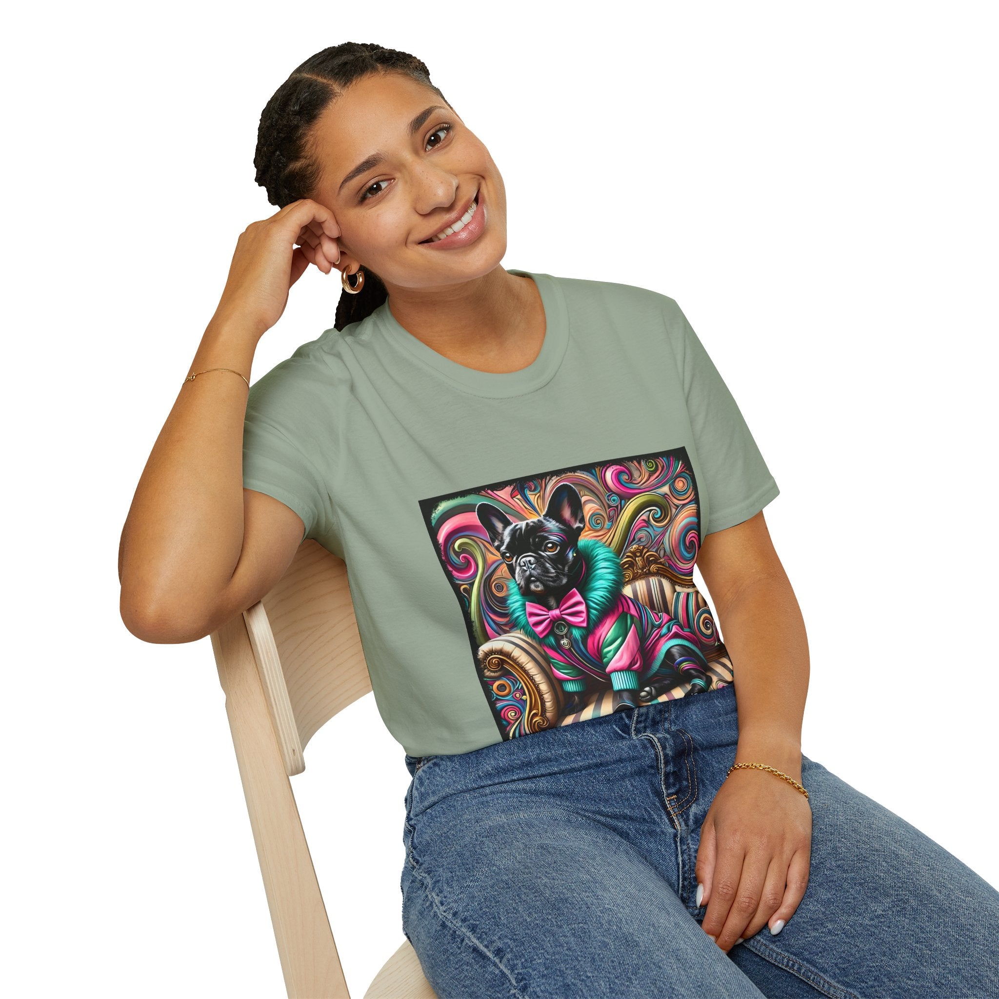 Woman sitting in sage green dog t-shirt with black French Bulldog in pink and teal outfit on swirl background and settee.