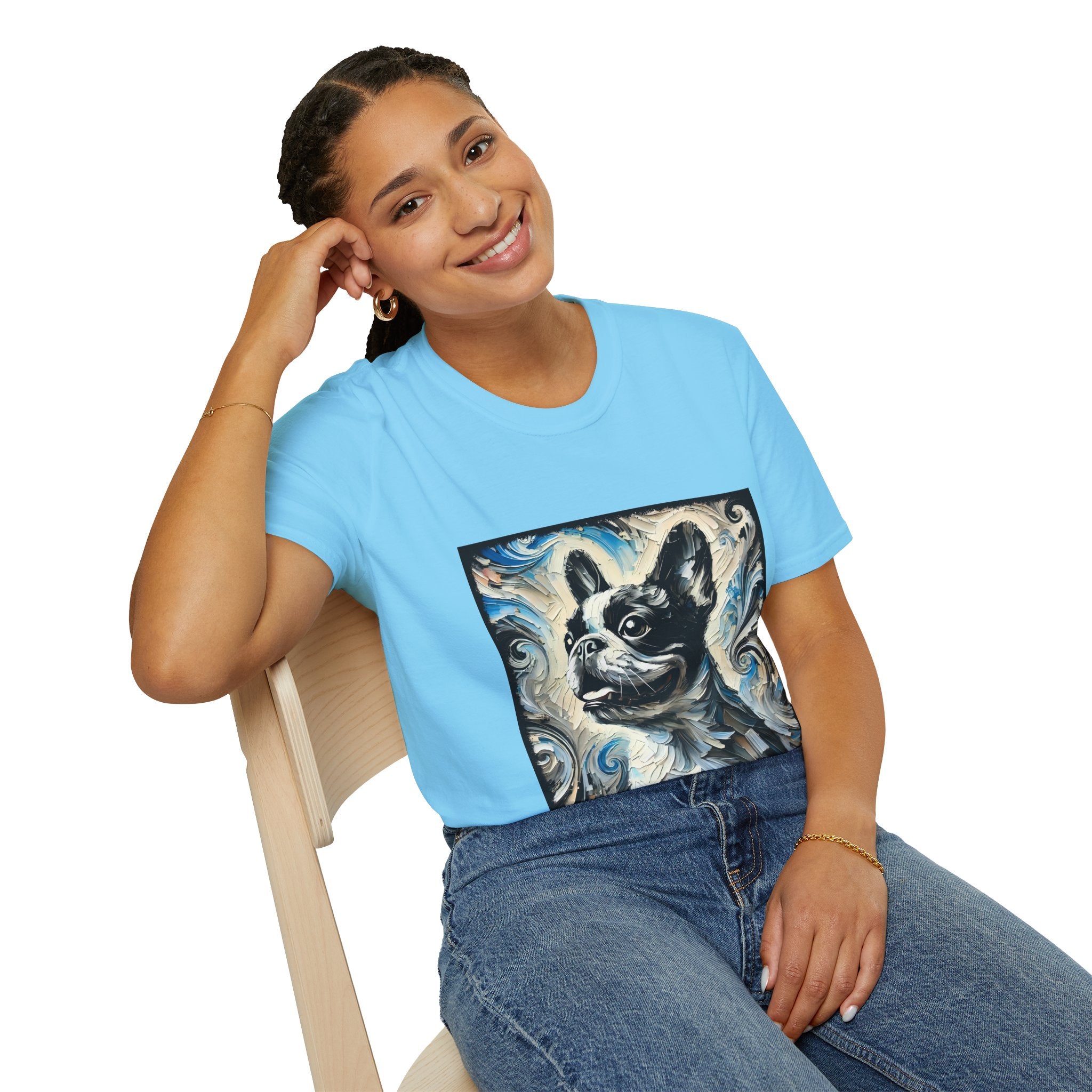 Woman sitting in sky blue dog t-shirt featuring black and white French Bulldog portrait on swirl-patterned background.