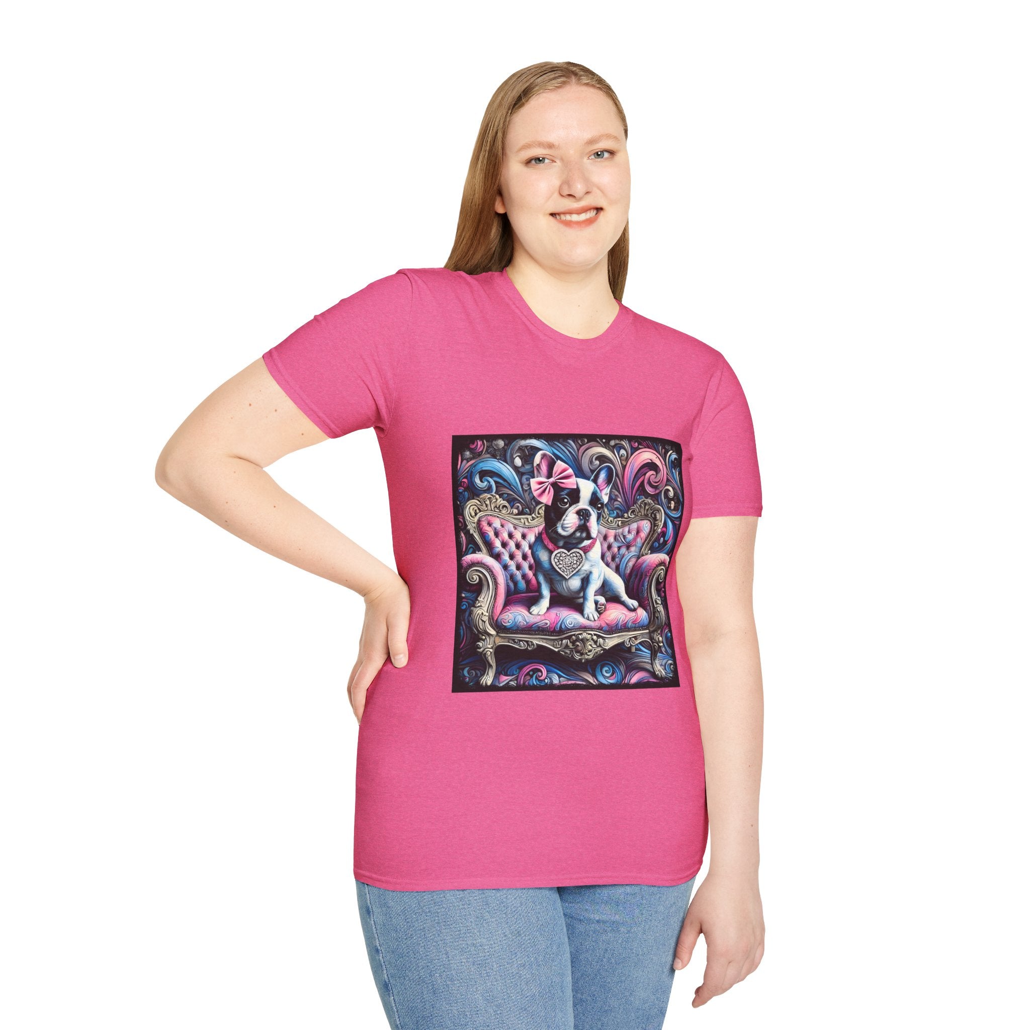 Female model in bright pink dog t-shirt featuring a black and white French Bulldog with a pink bow, seated on a tufted pink and gold settee against a swirling blue, pink, and purple expressionist-style background.