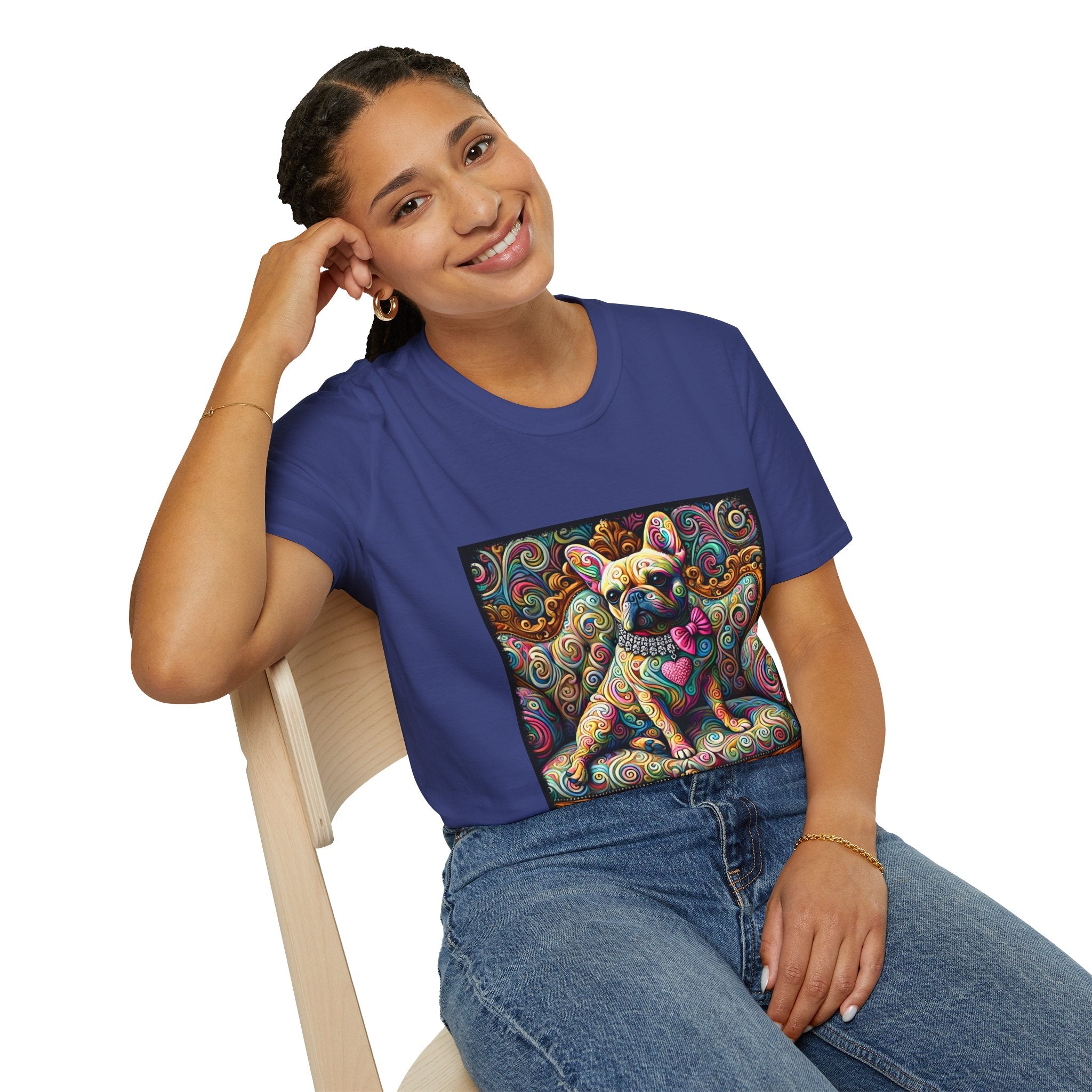 Woman sitting  in royal blue dog t-shirt featuring a tan French Bulldog with pink bow and heart on a vivid rainbow swirl couch.