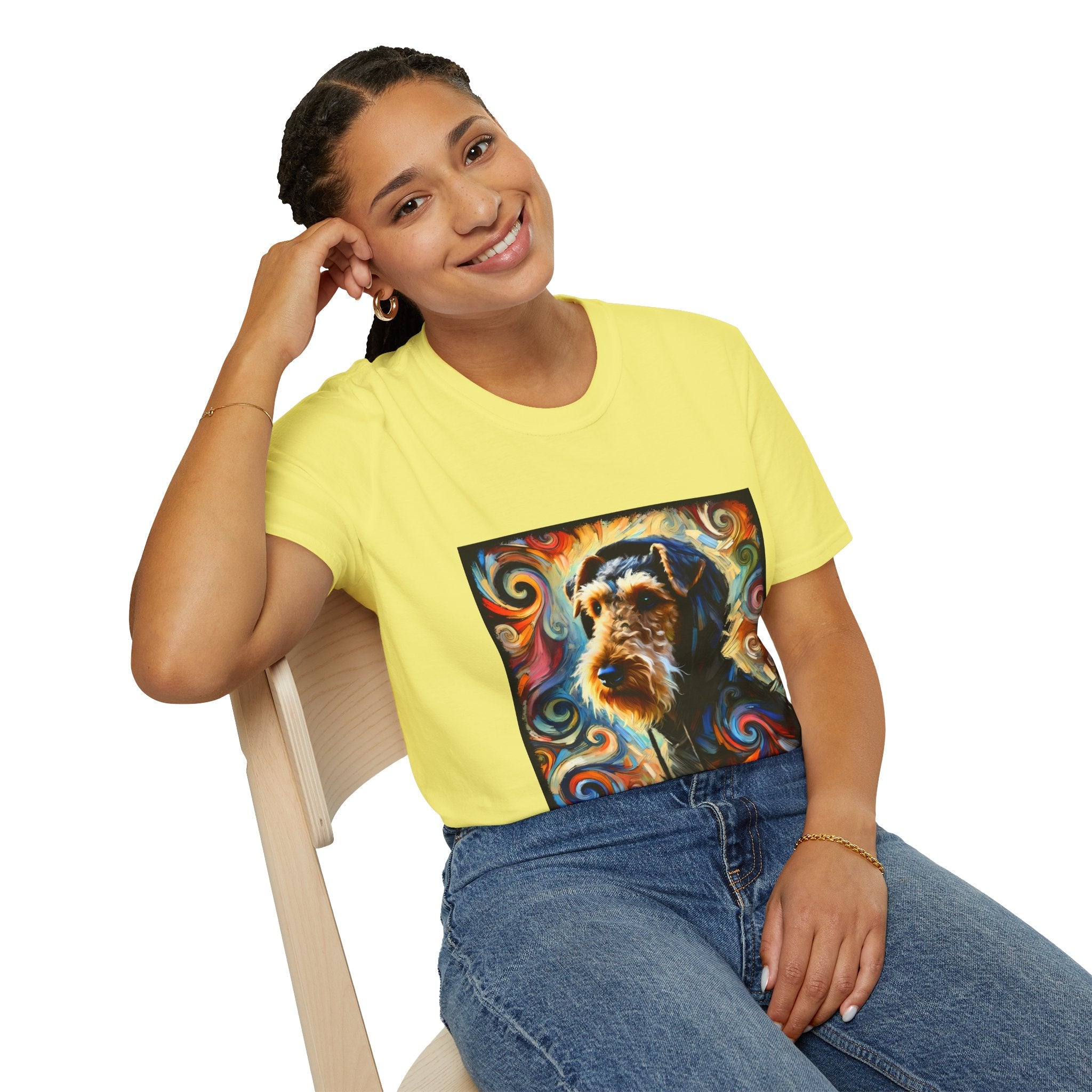 Female sitting in yellow dog t-shirt with Airedale terrier in hoodie and vibrant multicolor swirl background.