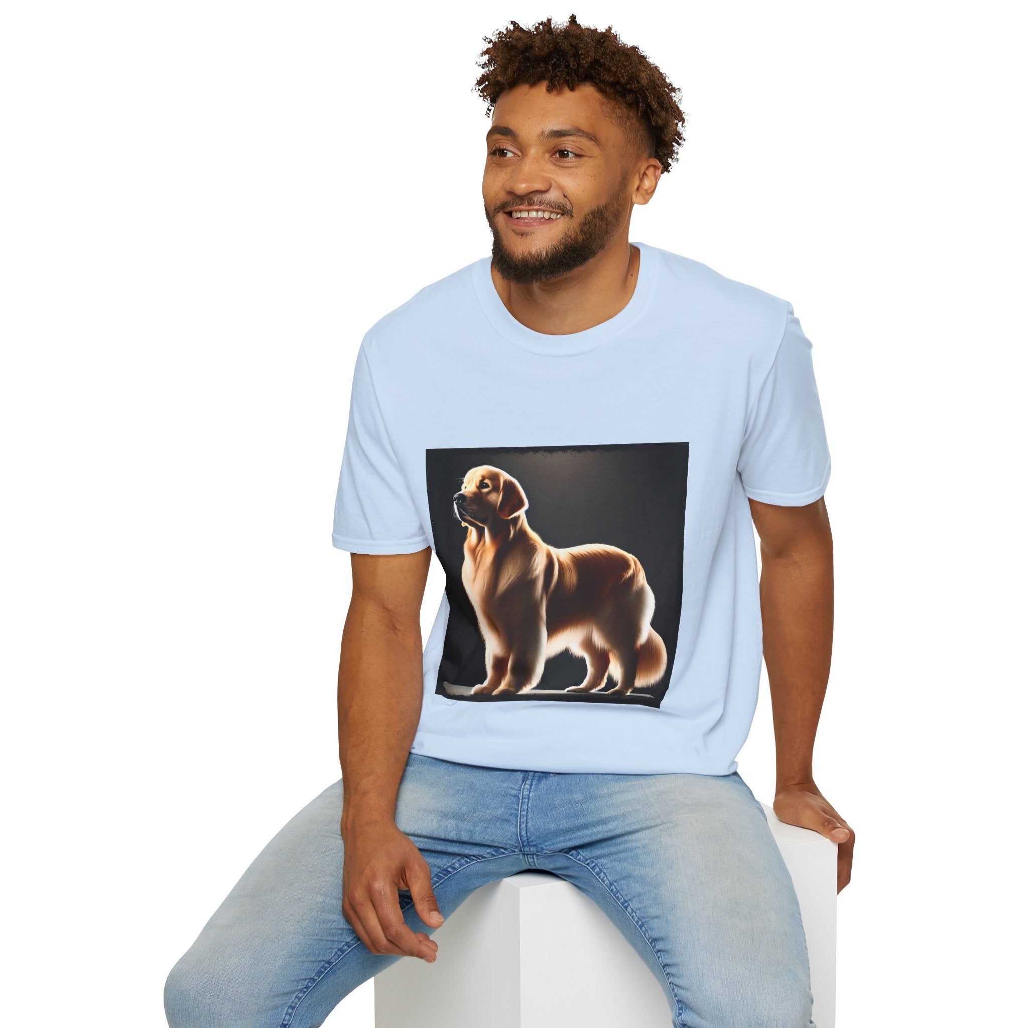 Male model in light blue dog t-shirt with golden retriever standing tall under spotlight on black background.