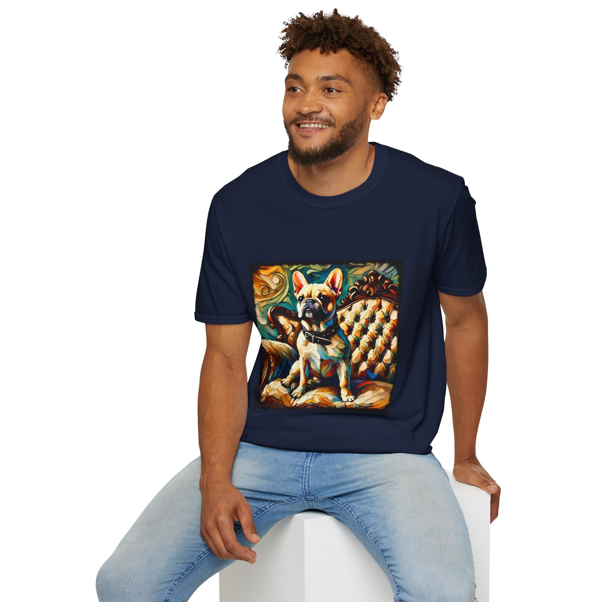 Male model in navy blue dog t-shirt featuring fawn French Bulldog with collar on golden tufted settee and bold swirl backdrop.