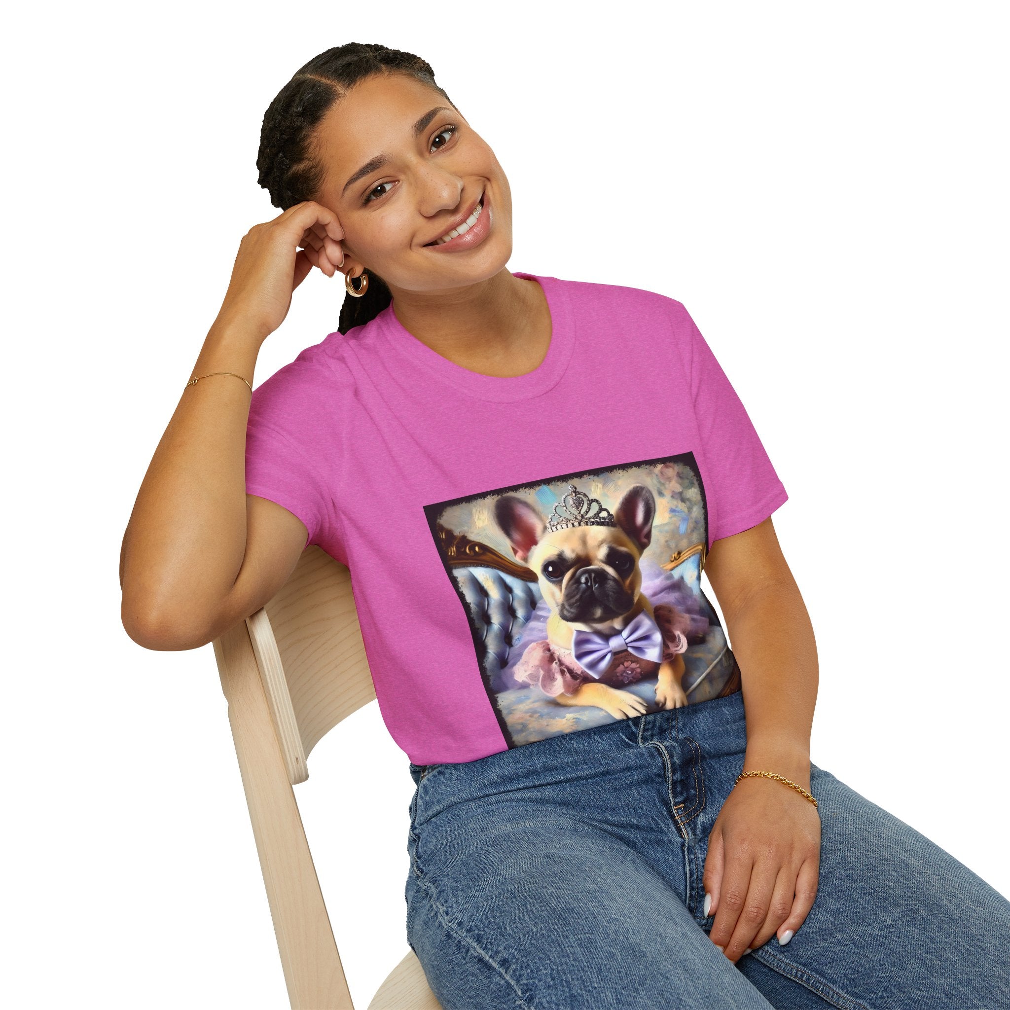 Woman sitting in vibrant pink dog t-shirt featuring French Bulldog in tiara and tutu on royal chair with dreamy pastel background.