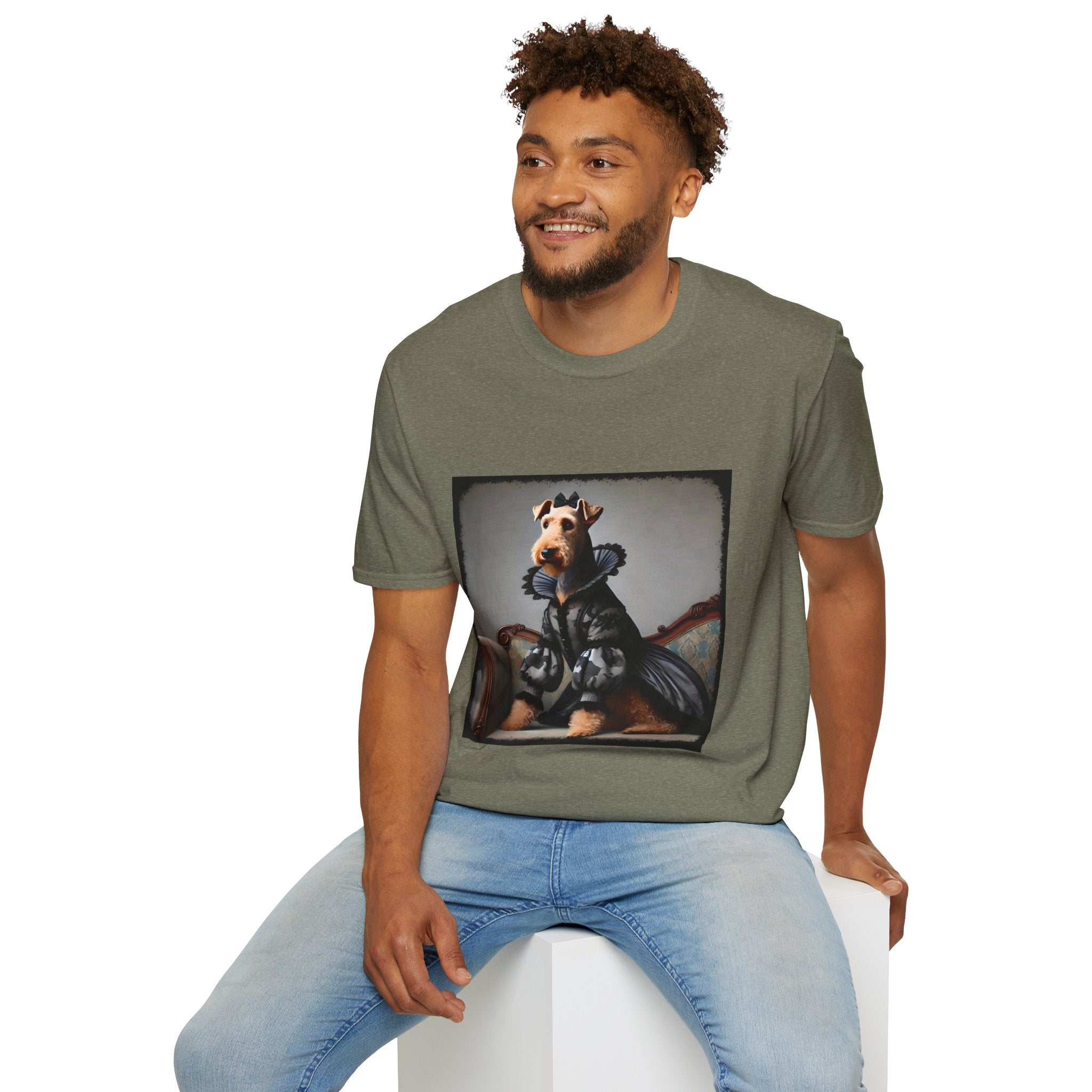 Male model in heather military green dog t-shirt featuring Airedale terrier in camouflage Renaissance gown seated on settee.