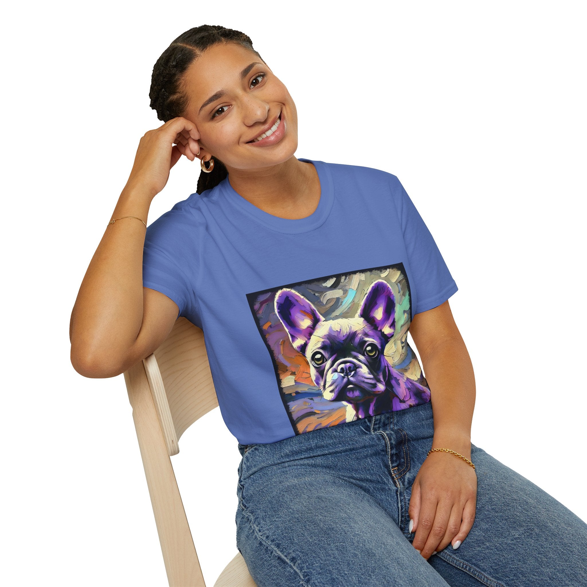 Woman sitting in cornflower blue dog t-shirt featuring a lavender purple French Bulldog with swirling brushstrokes of teal, orange, and cream.