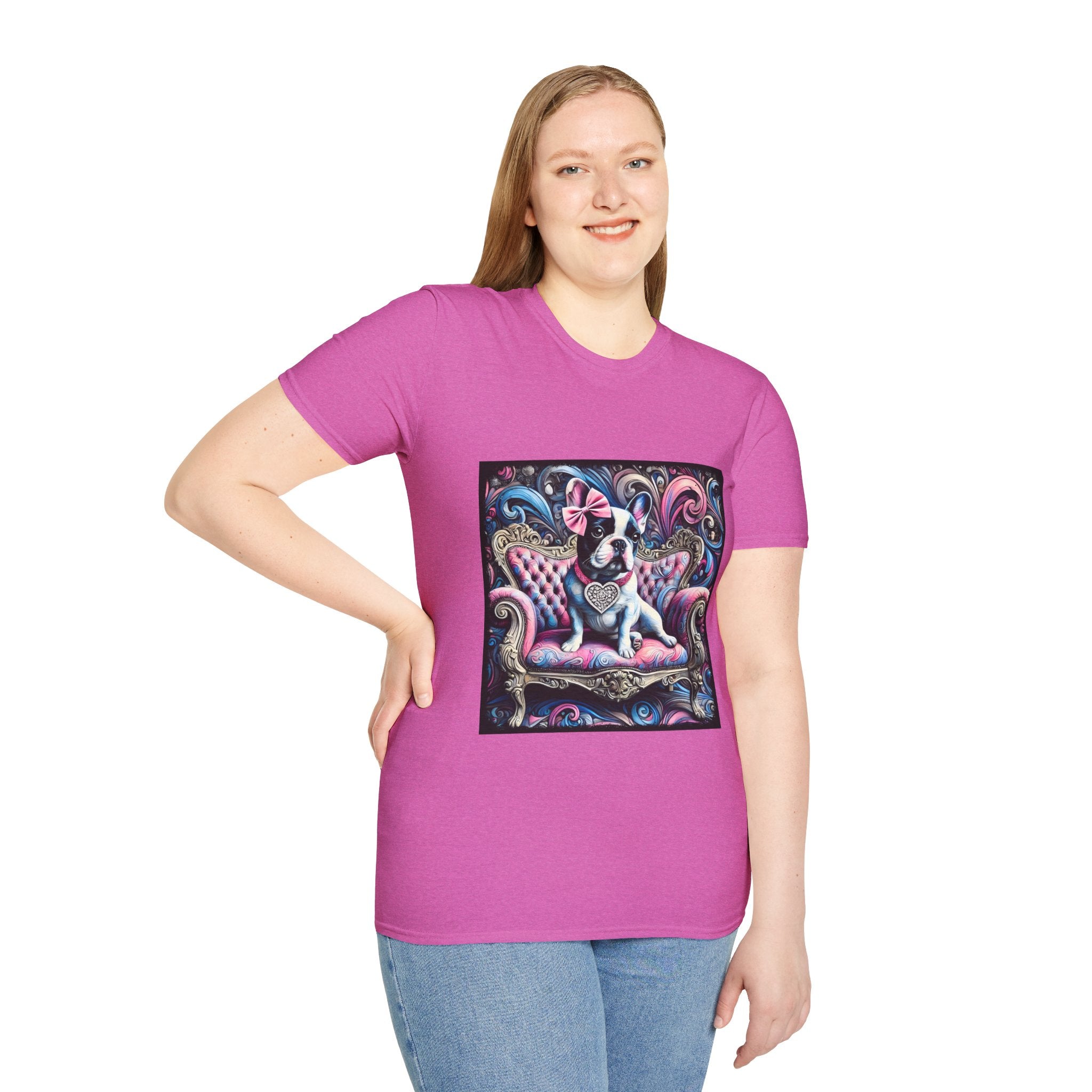 Female model in orchid pink dog t-shirt featuring a black and white French Bulldog with a pink bow, seated on a tufted pink and gold settee against a swirling blue, pink, and purple expressionist-style background.