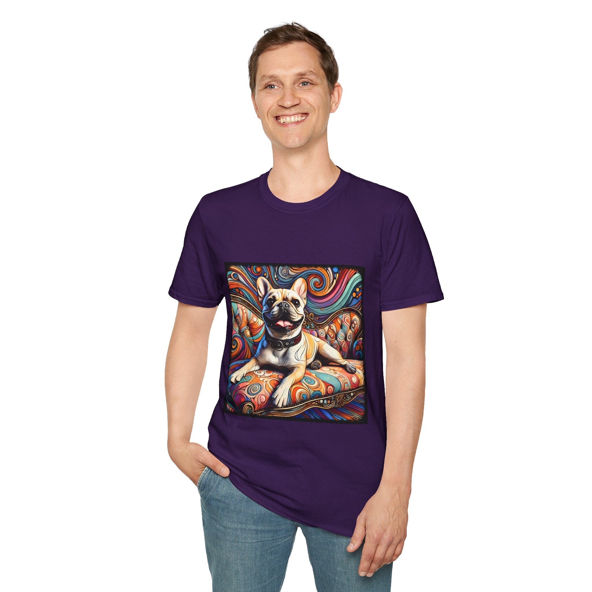 Man smiling in purple dog t-shirt featuring fawn French Bulldog with collar on swirl settee and vivid background.