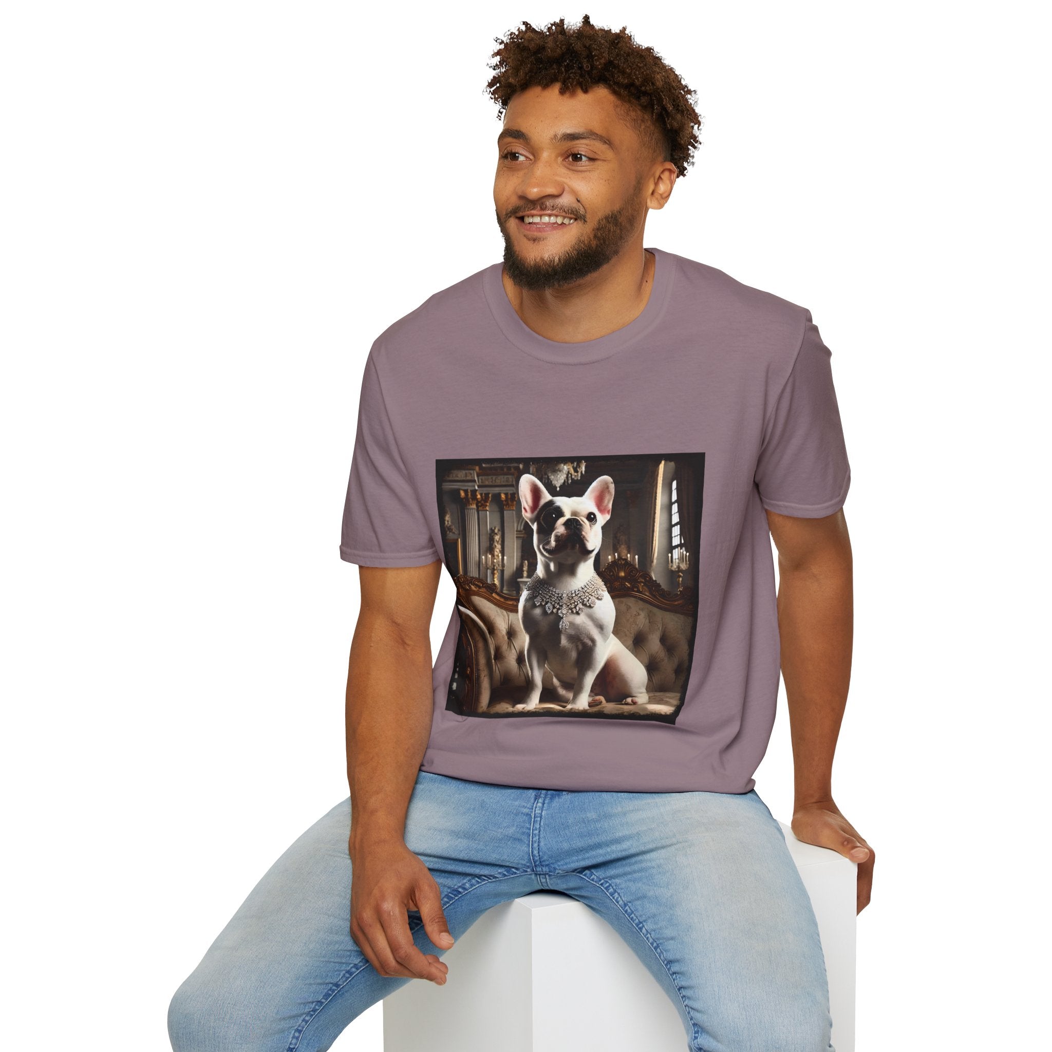 Male model in mauve dog t-shirt featuring white French Bulldog in jeweled necklace on tufted settee in elegant palace setting.