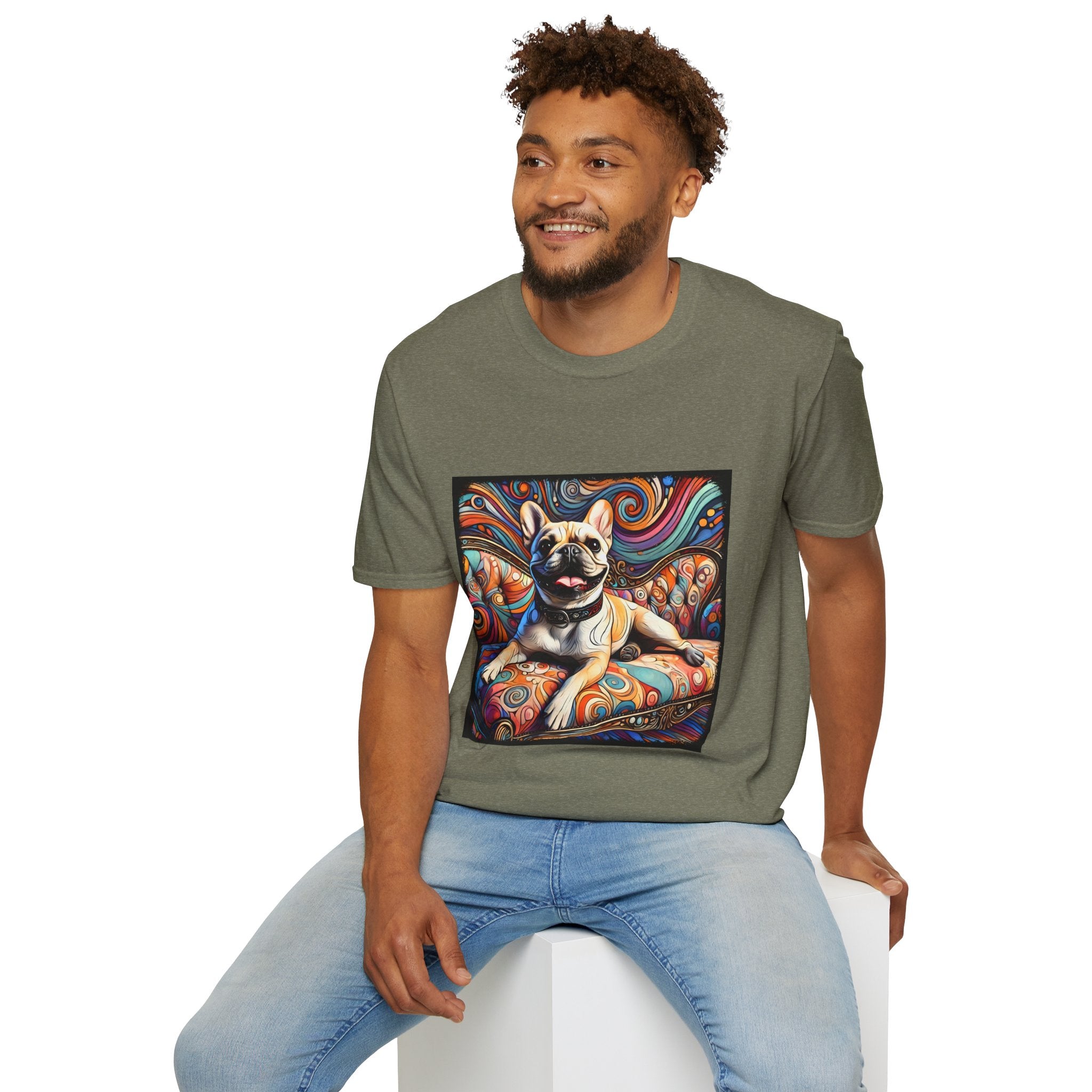 Male model in heather military green dog t-shirt featuring fawn French Bulldog with collar on swirl settee and vivid background.