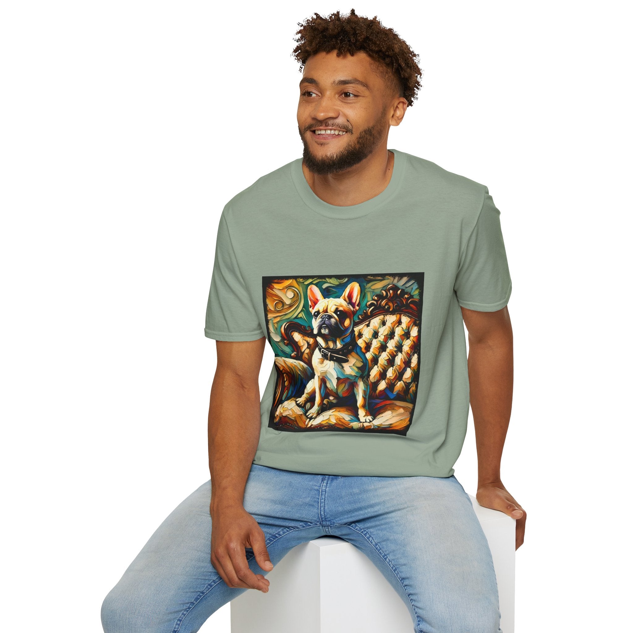Male model in sage green dog t-shirt featuring fawn French Bulldog with collar on golden tufted settee and bold swirl backdrop.