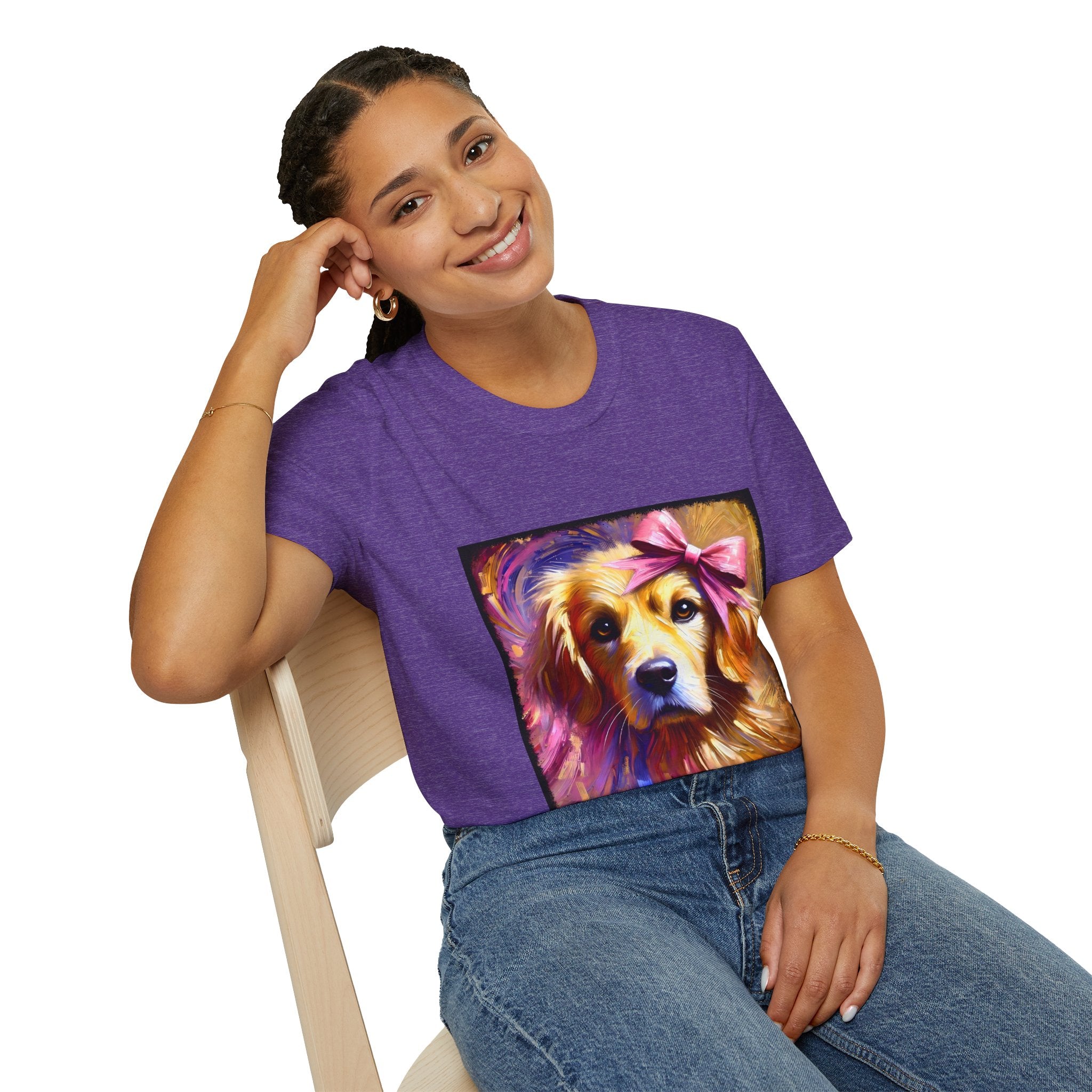 Female model in heather purple dog t-shirt featuring golden retriever with pink bow on head, bold brushstroke background in pinks.