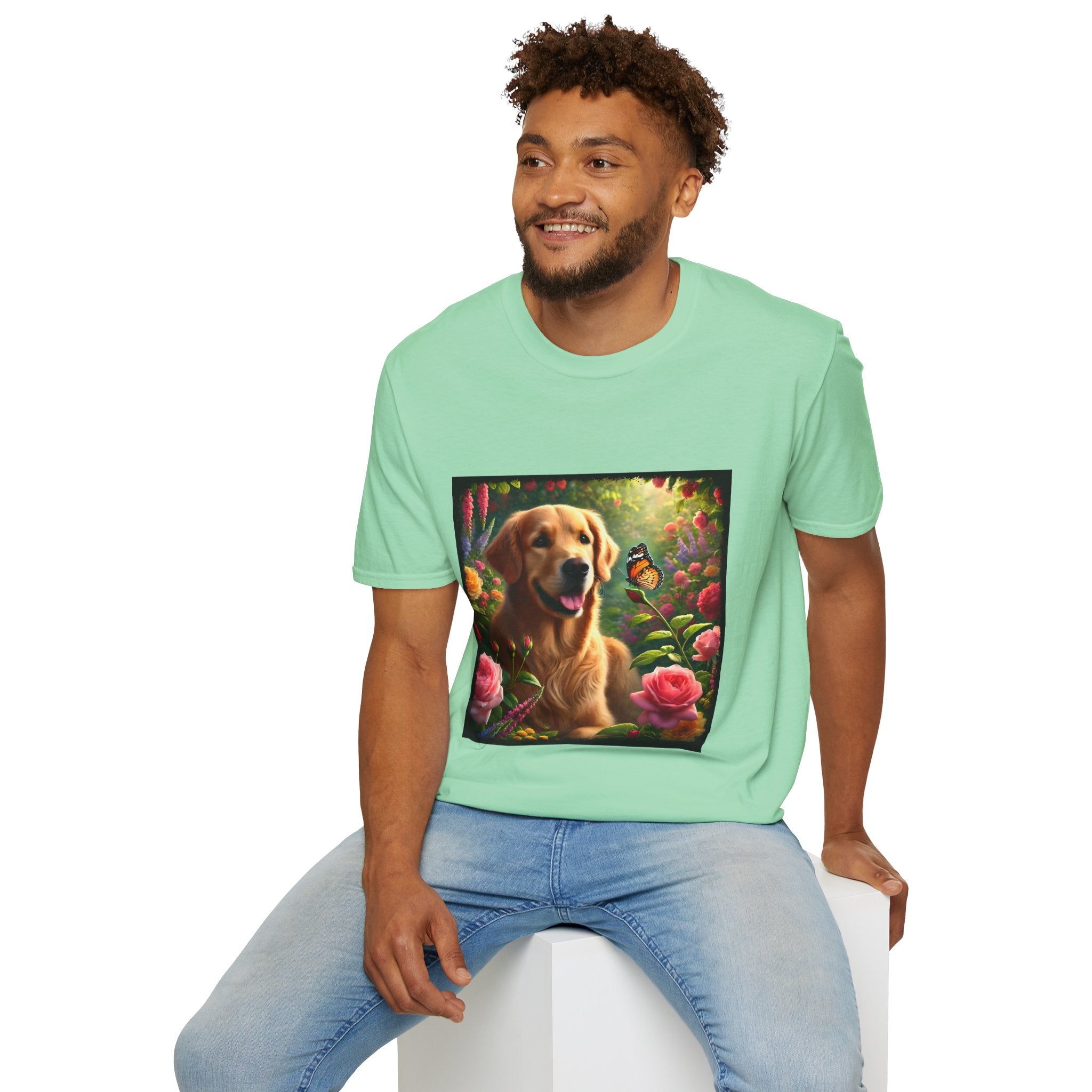 Male model wears mint green dog t-shirt featuring a golden retriever in a vibrant garden with roses, wildflowers, and a butterfly.