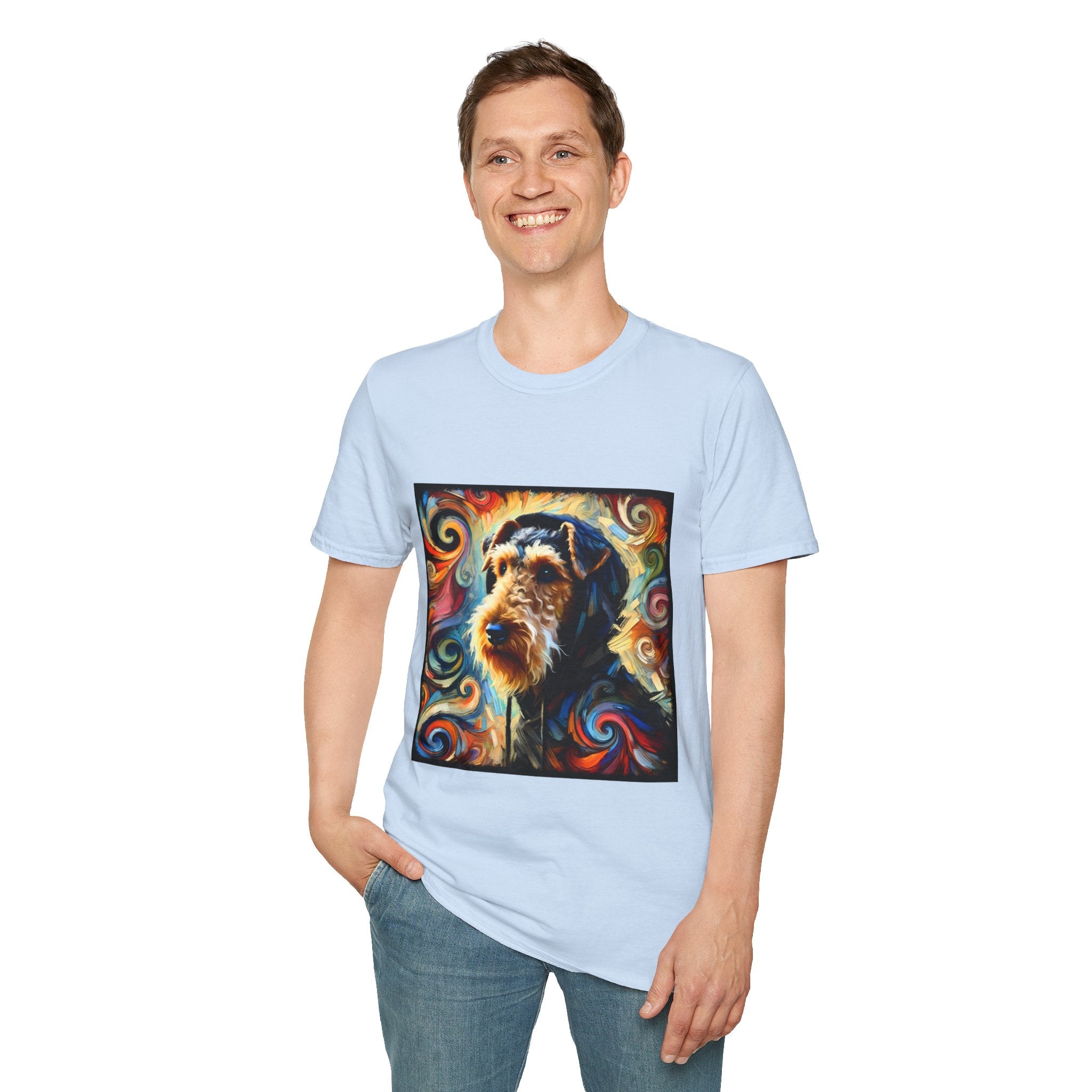 Male standing in light blue dog t-shirt with Airedale terrier in hoodie and vibrant multicolor swirl background.