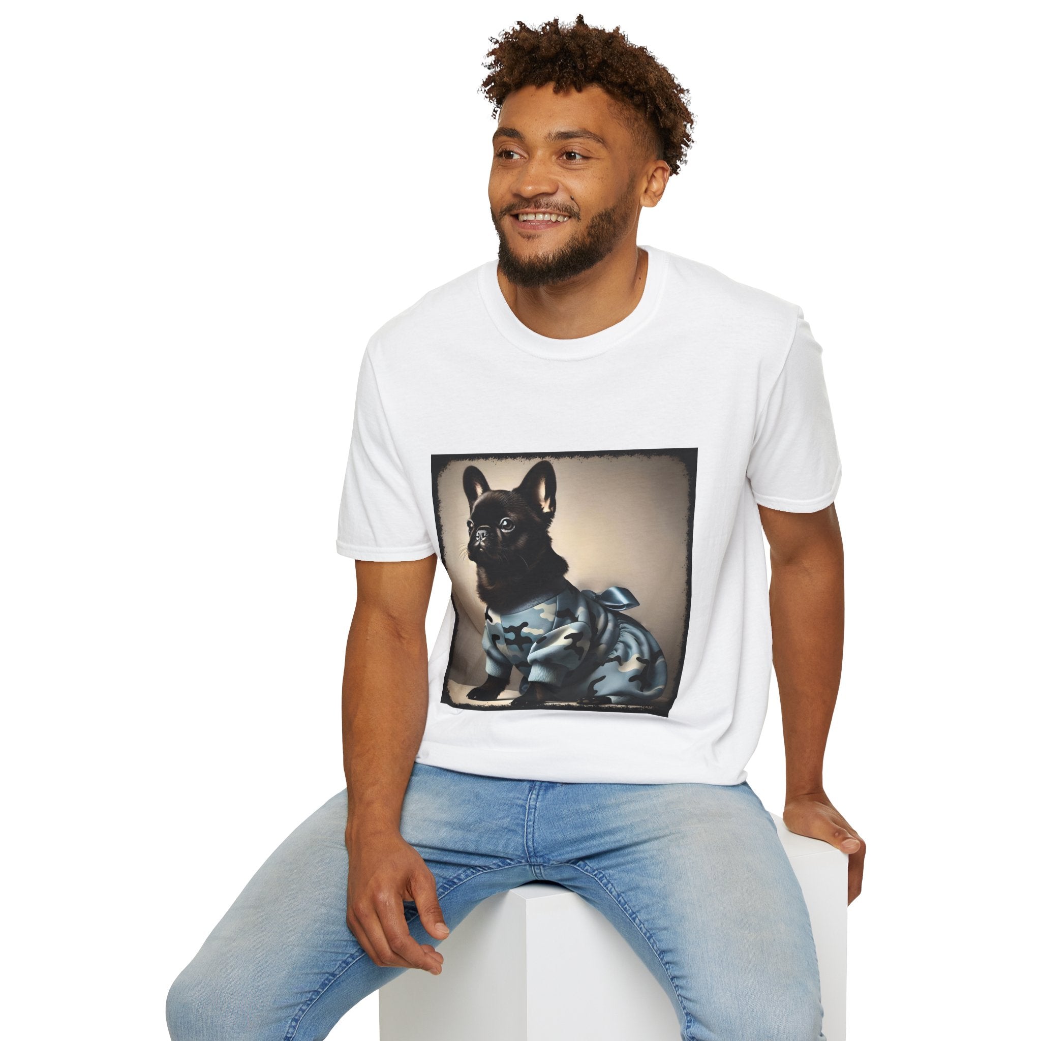 Male model wearing white dog t-shirt featuring black French Bulldog in blue camo outfit with bow, set in soft vintage portrait.