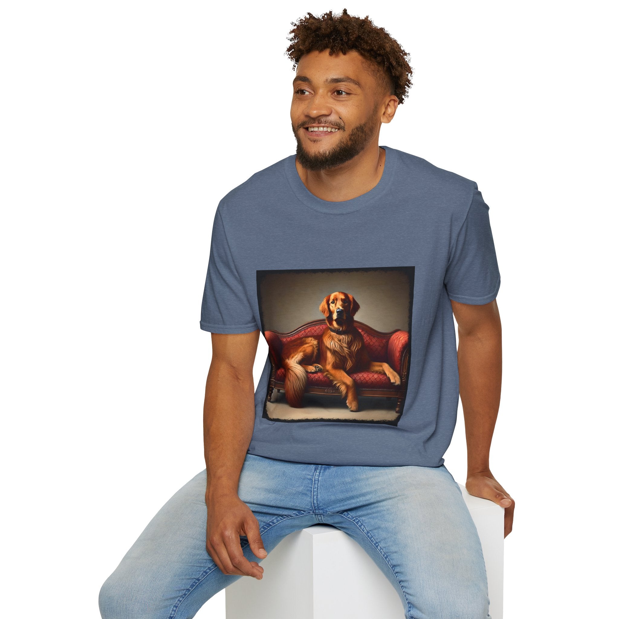 Male model in heather indigo dog t-shirt with golden retriever lounging on vintage red settee with regal posture.