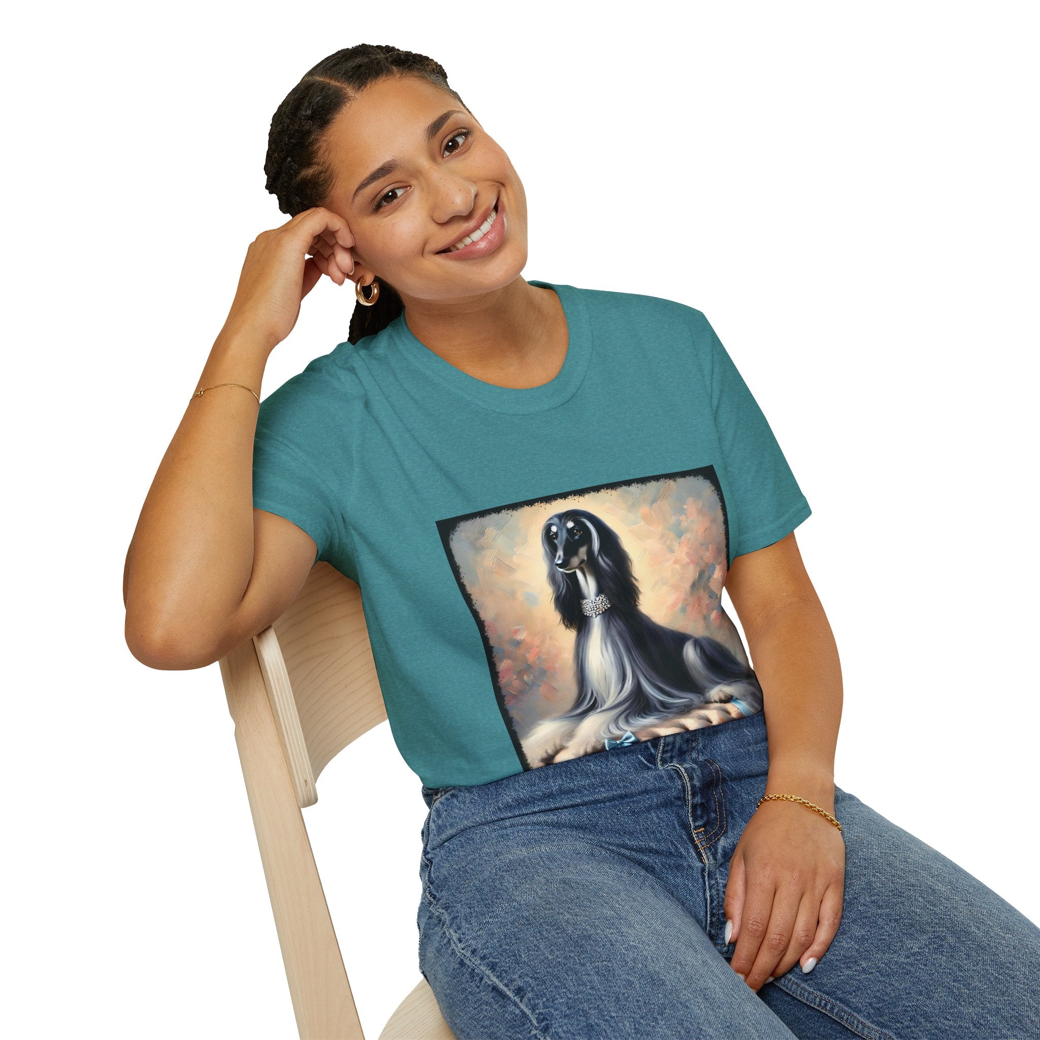 Front view of woman wearing teal dog t-shirt featuring black and white Afghan Hound on cushion with diamond necklace, pastel background