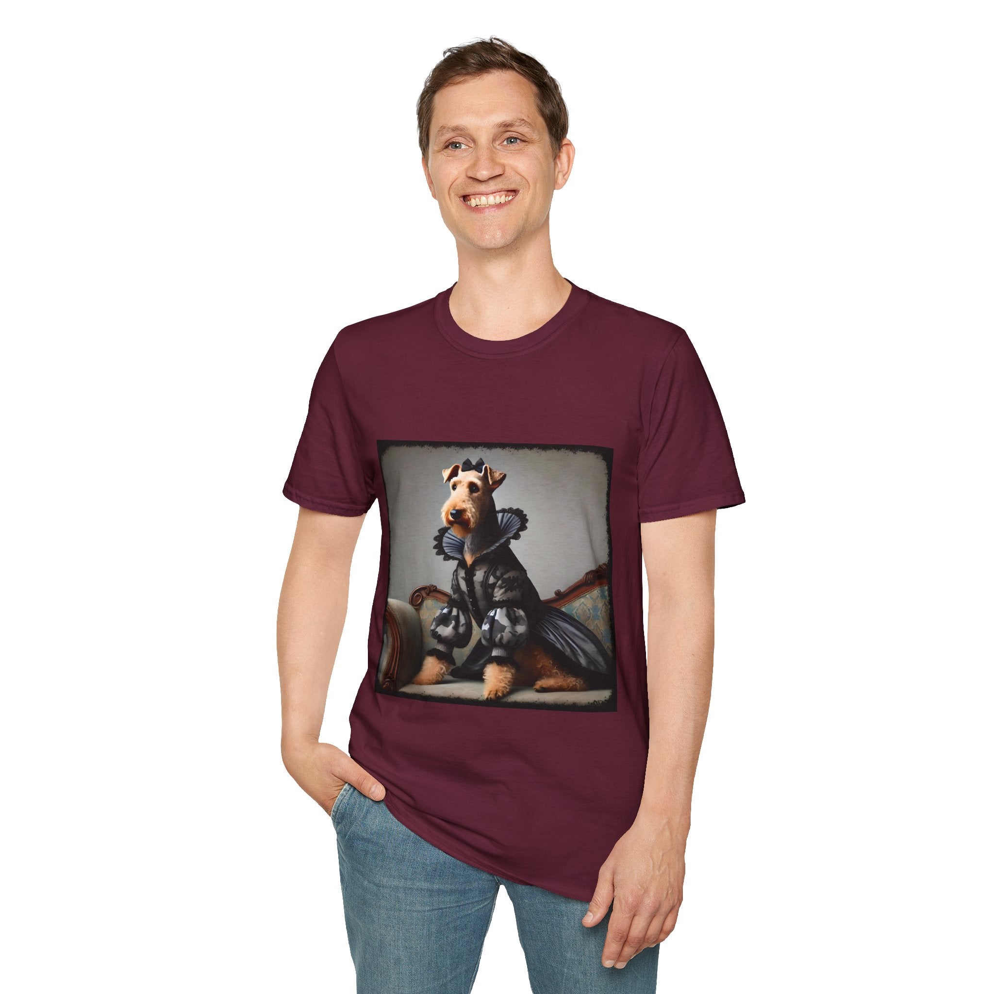 Male model in maroon dog t-shirt featuring Airedale terrier in camouflage Renaissance gown seated on settee.