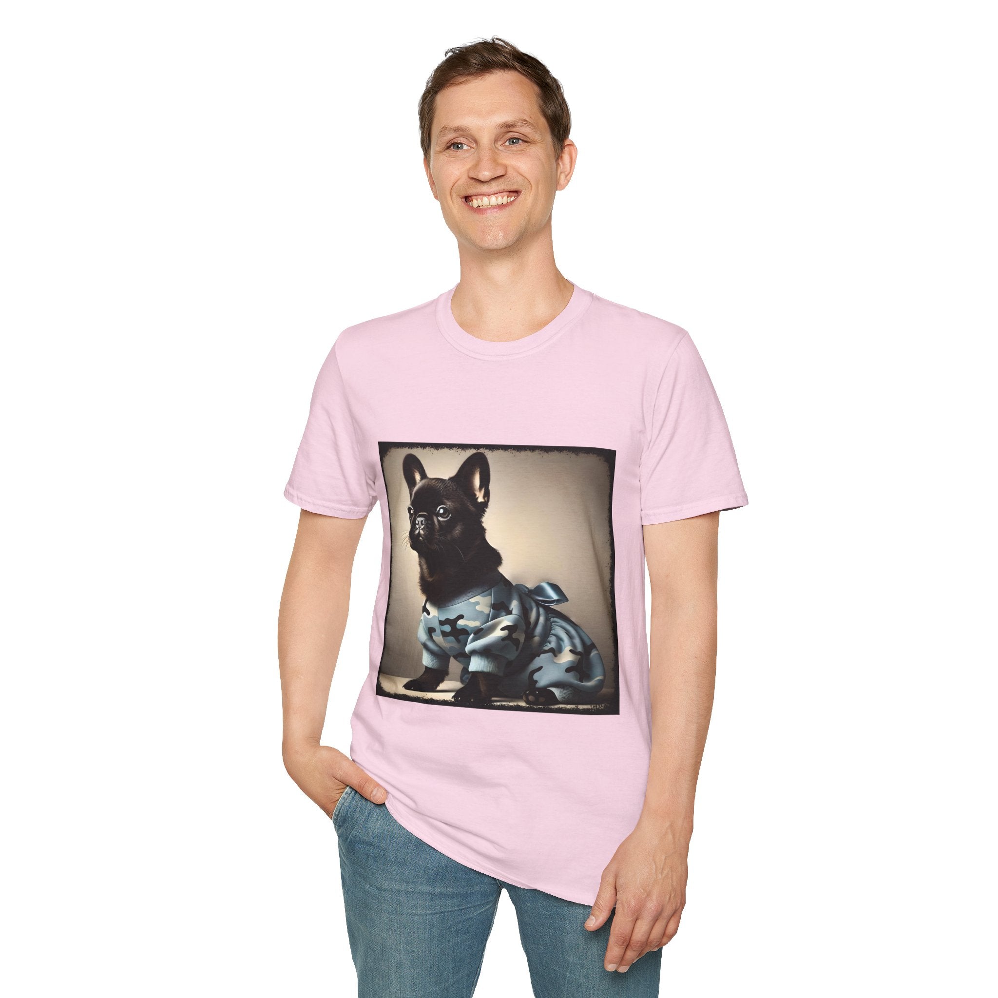 Man smiling wearing light pink dog t-shirt featuring black French Bulldog in blue camo outfit with bow, set in soft vintage portrait.