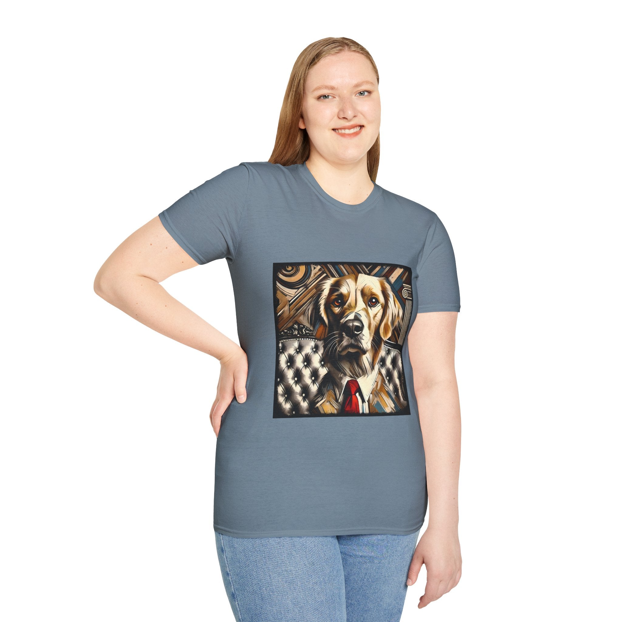 Female model in stone blue dog t-shirt featuring golden retriever in suit and red tie, seated on tufted chair with abstract backdrop.