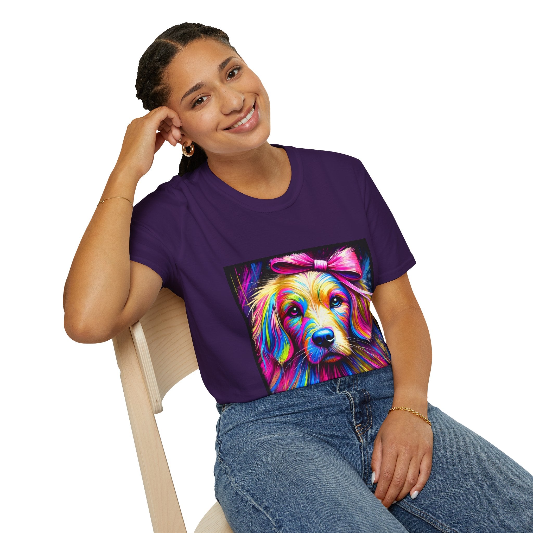 Female model in purple dog t-shirt featuring neon-colored golden retriever with pink bow on vibrant electric abstract backdrop.