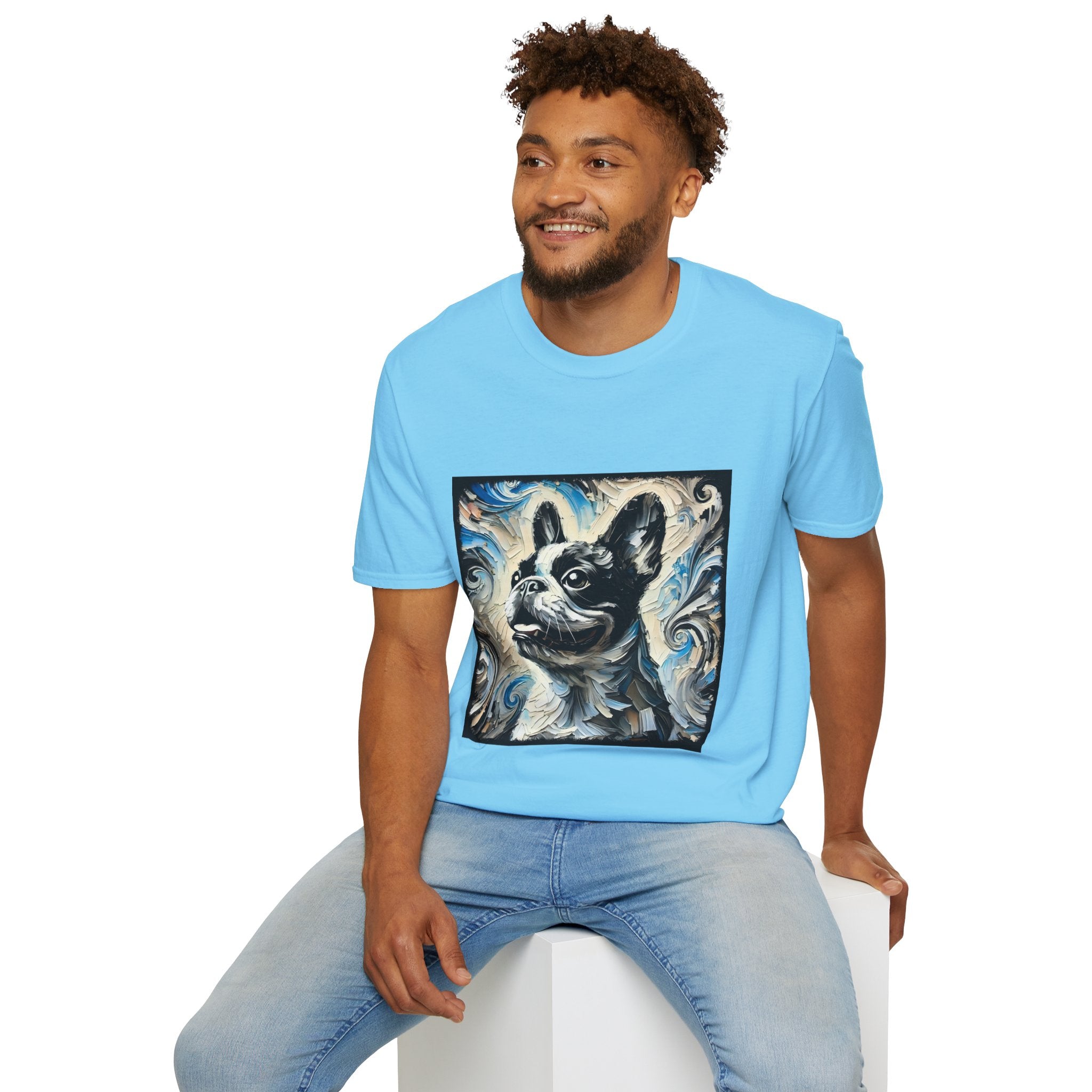 Male model wearing sky blue dog t-shirt with black and white French Bulldog portrait on swirl-patterned vintage background.
