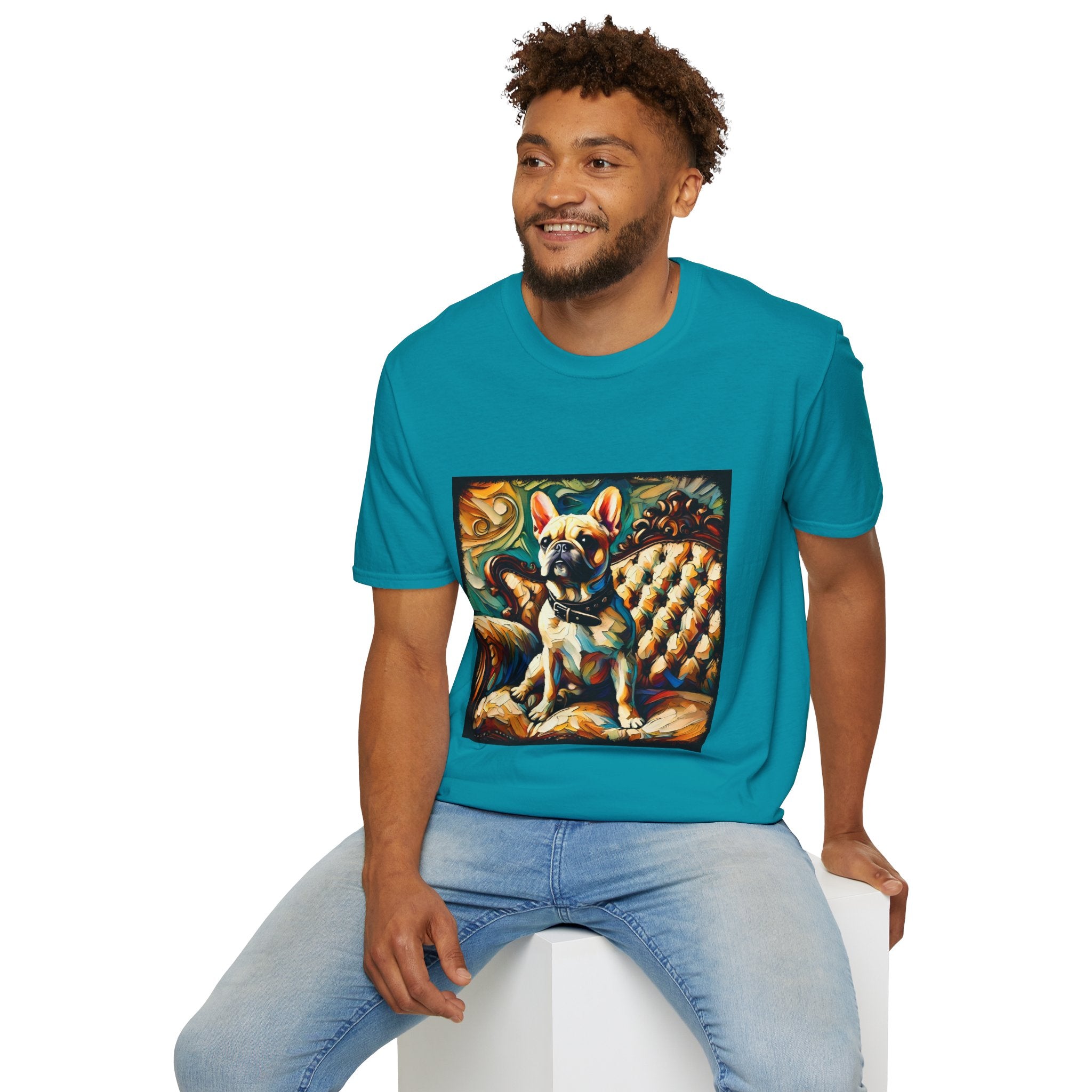 Male model in tropical blue dog t-shirt featuring fawn French Bulldog with collar on golden tufted settee and bold swirl backdrop.