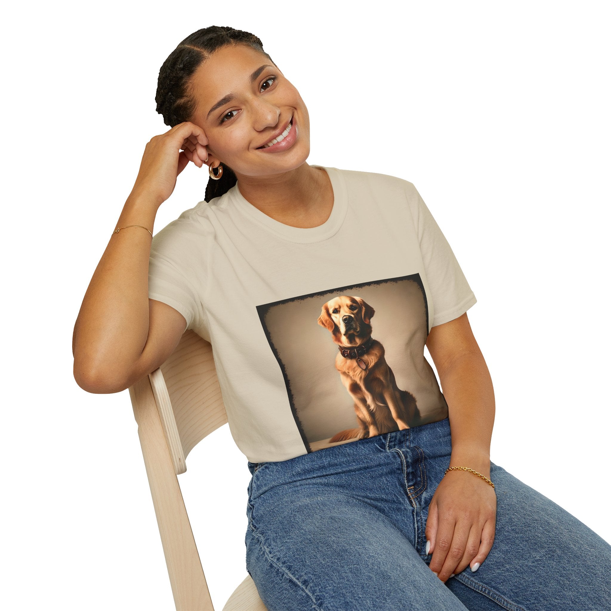 Female model in sand dog t-shirt featuring golden retriever in brown collar, seated against a neutral tan backdrop.
