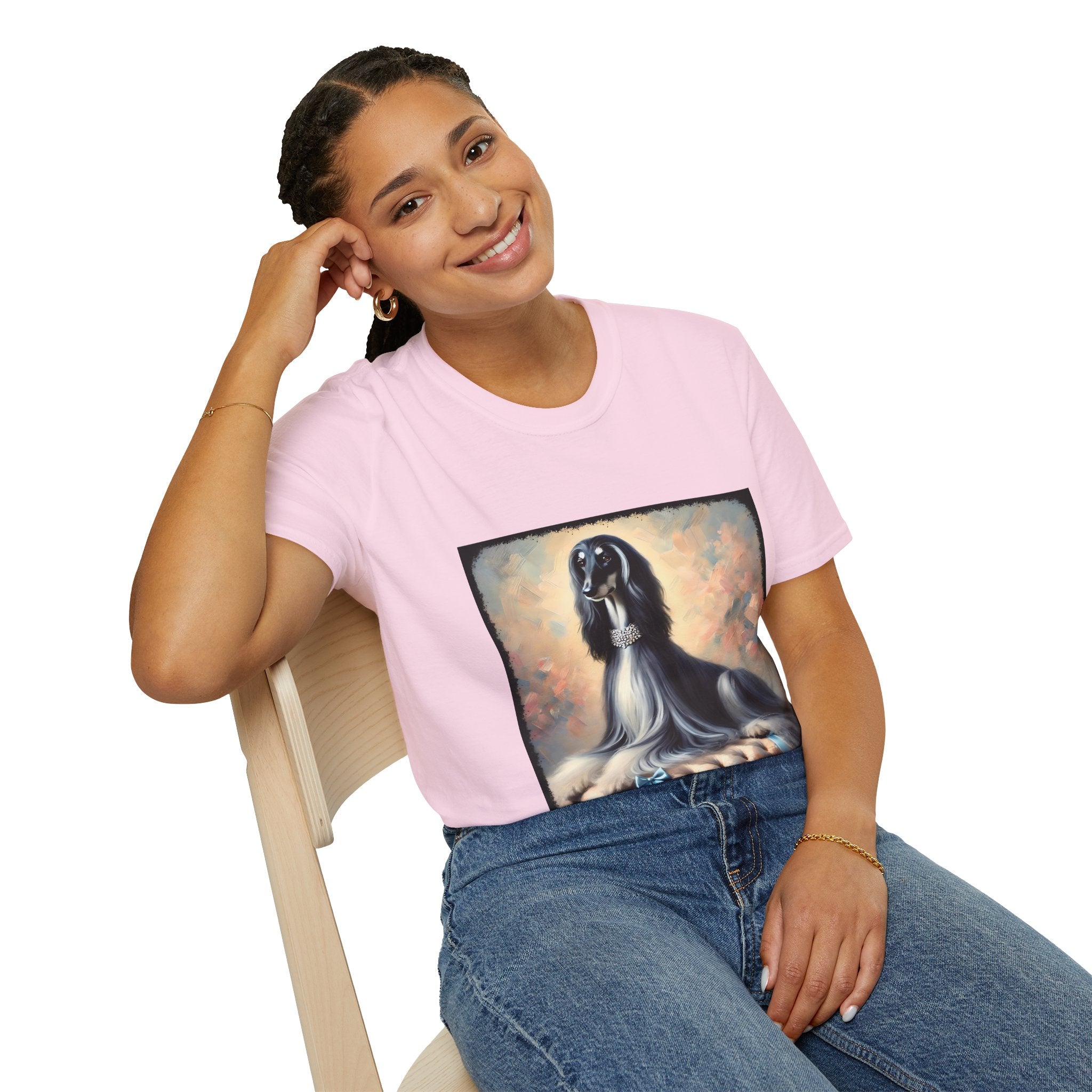 Front view of person wearing light pink dog t-shirt featuring black and white Afghan Hound on cushion with diamond necklace, pastel background