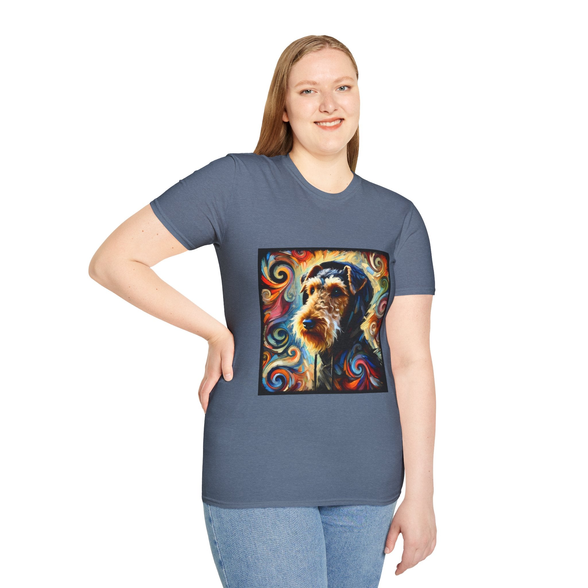 Female standing in heather indigo dog t-shirt with Airedale terrier in hoodie and vibrant multicolor swirl background.