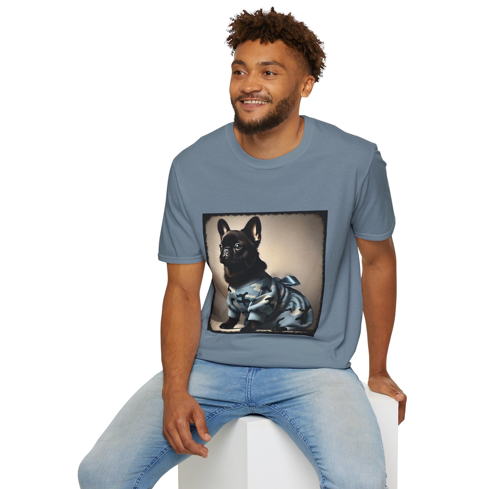 Male model wearing stone  blue dog t-shirt featuring black French Bulldog in blue camo outfit with bow, set in soft vintage portrait.