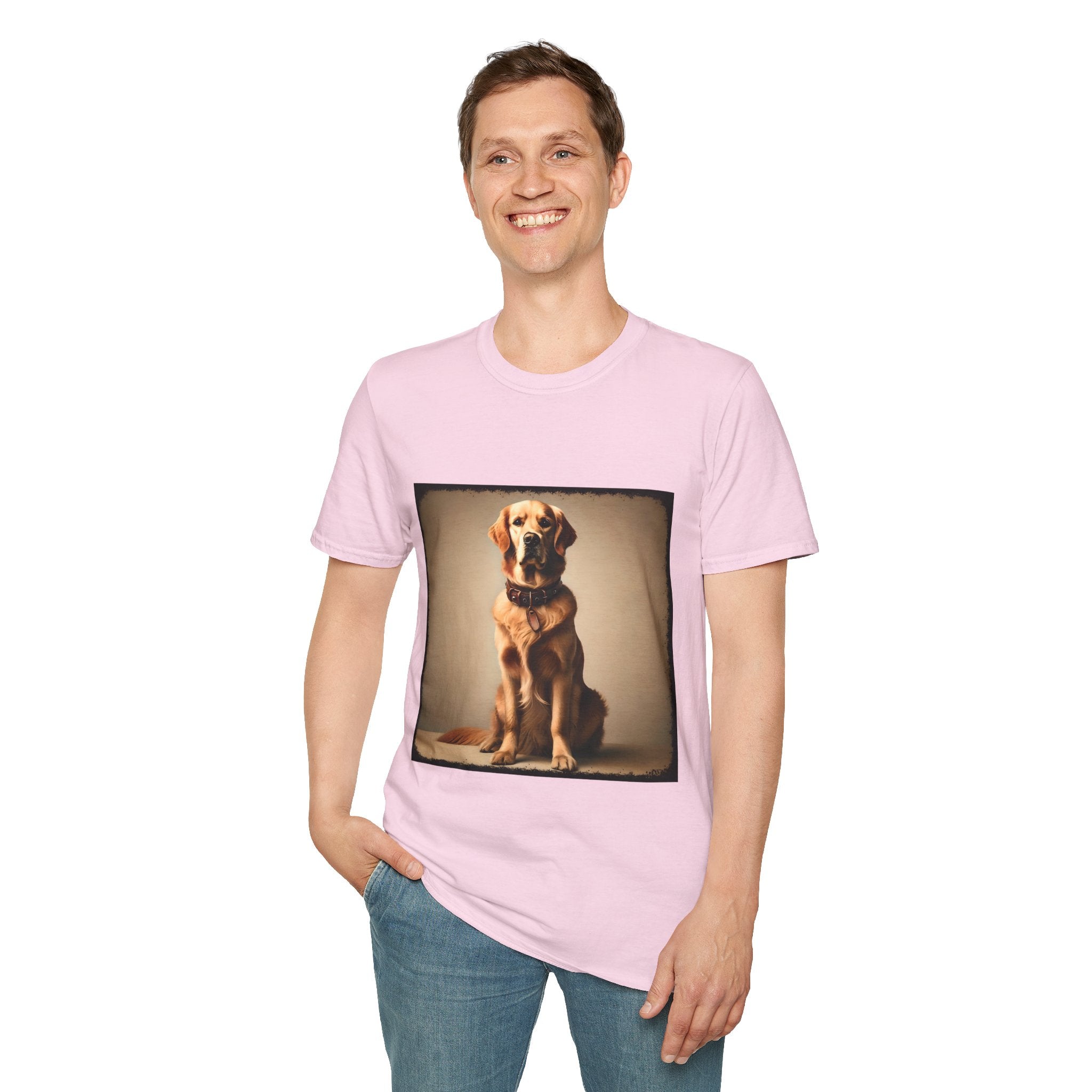 Male model in light pink dog t-shirt featuring golden retriever in brown collar, seated against a neutral tan backdrop.