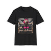 Black dog t-shirt featuring golden retriever with pink bow and fur outfit on black settee in edgy backdrop.