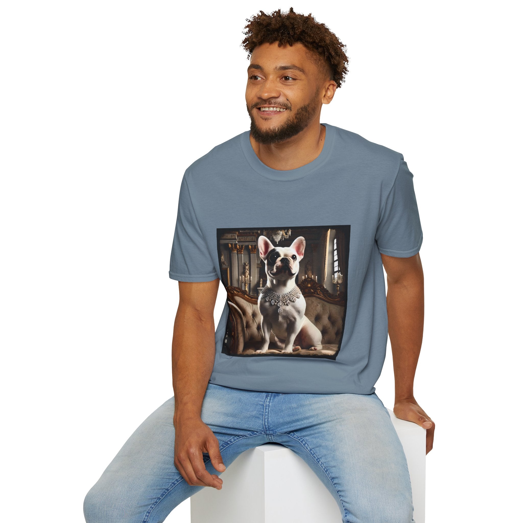 Male model in stone blue dog t-shirt featuring white French Bulldog in jeweled necklace on tufted settee in elegant palace setting.
