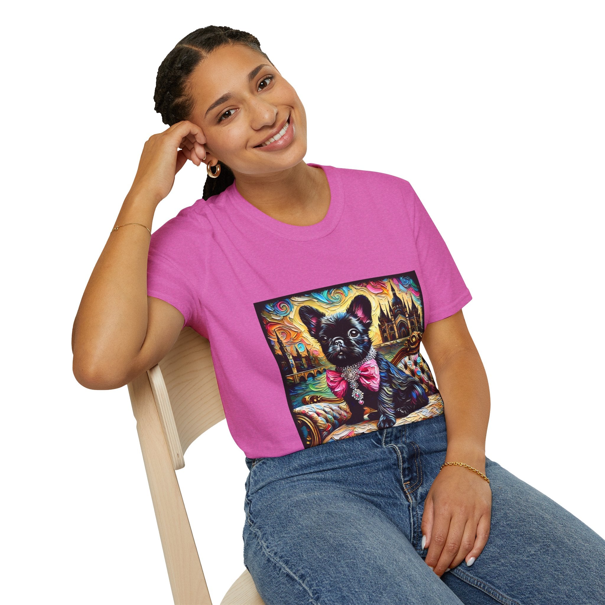Woman sitting wearing dark pink dog t-shirt featuring black French Bulldog in jeweled pink bow on settee with vivid castle background.