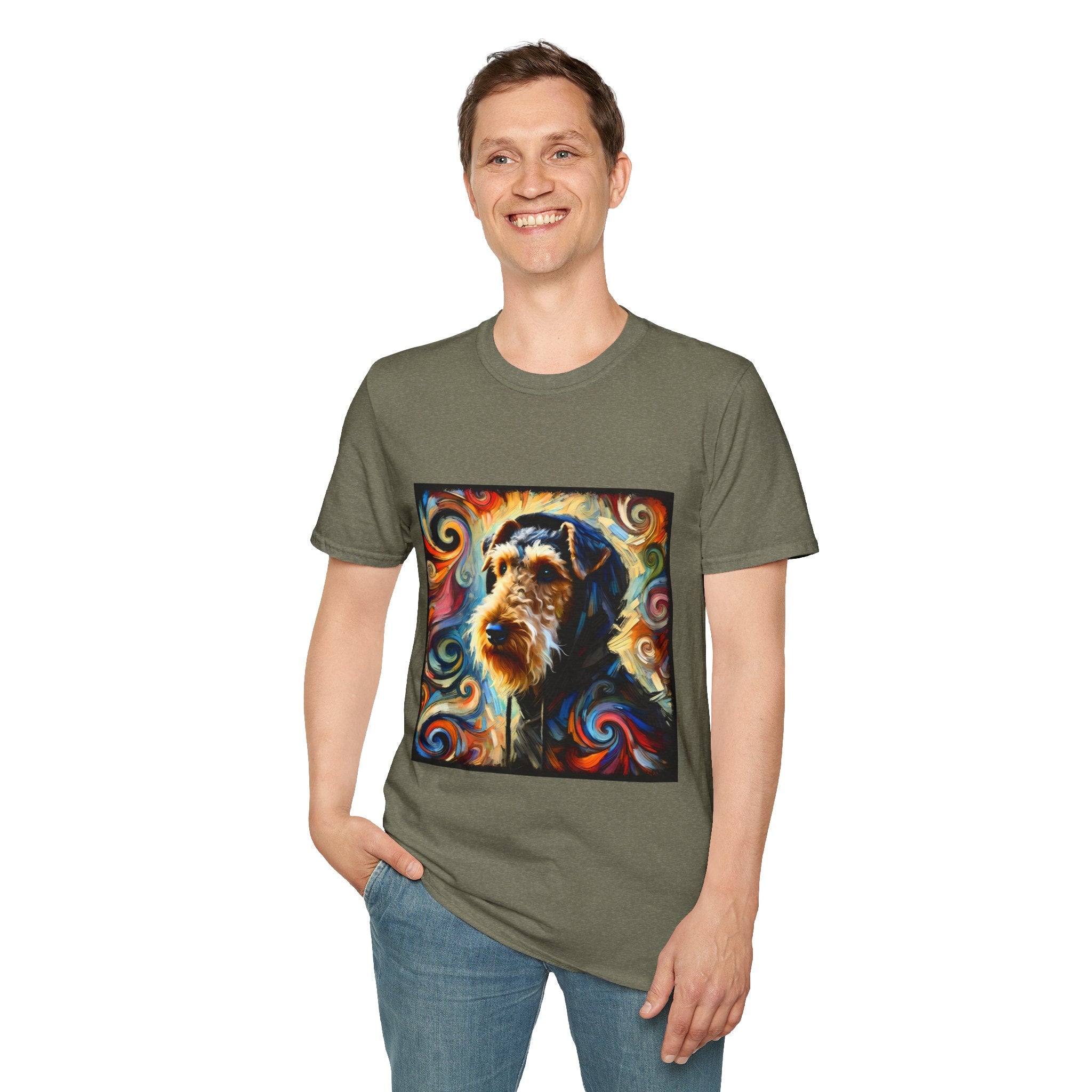 Male standing in heather military green dog t-shirt with Airedale terrier in hoodie and vibrant multicolor swirl background.