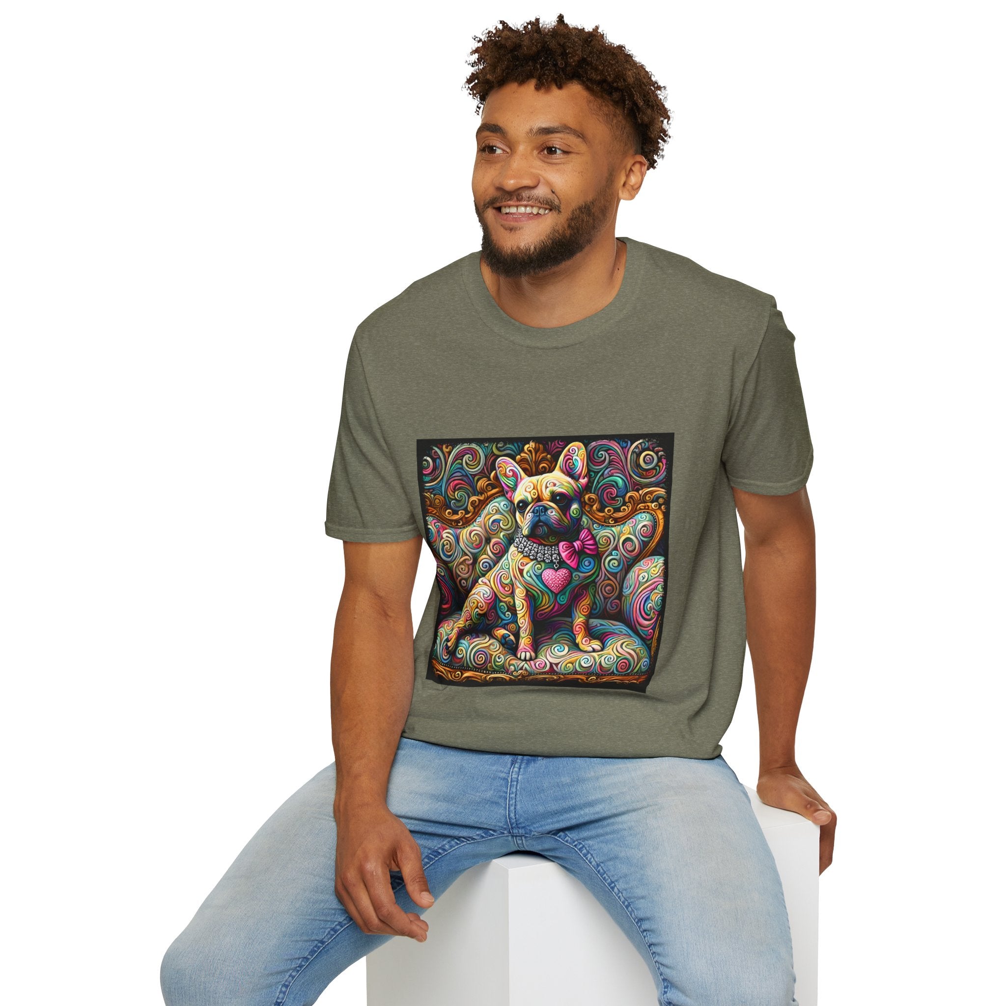 Male model in heather military green dog t-shirt featuring a tan French Bulldog with pink bow and heart on a vivid rainbow swirl couch.