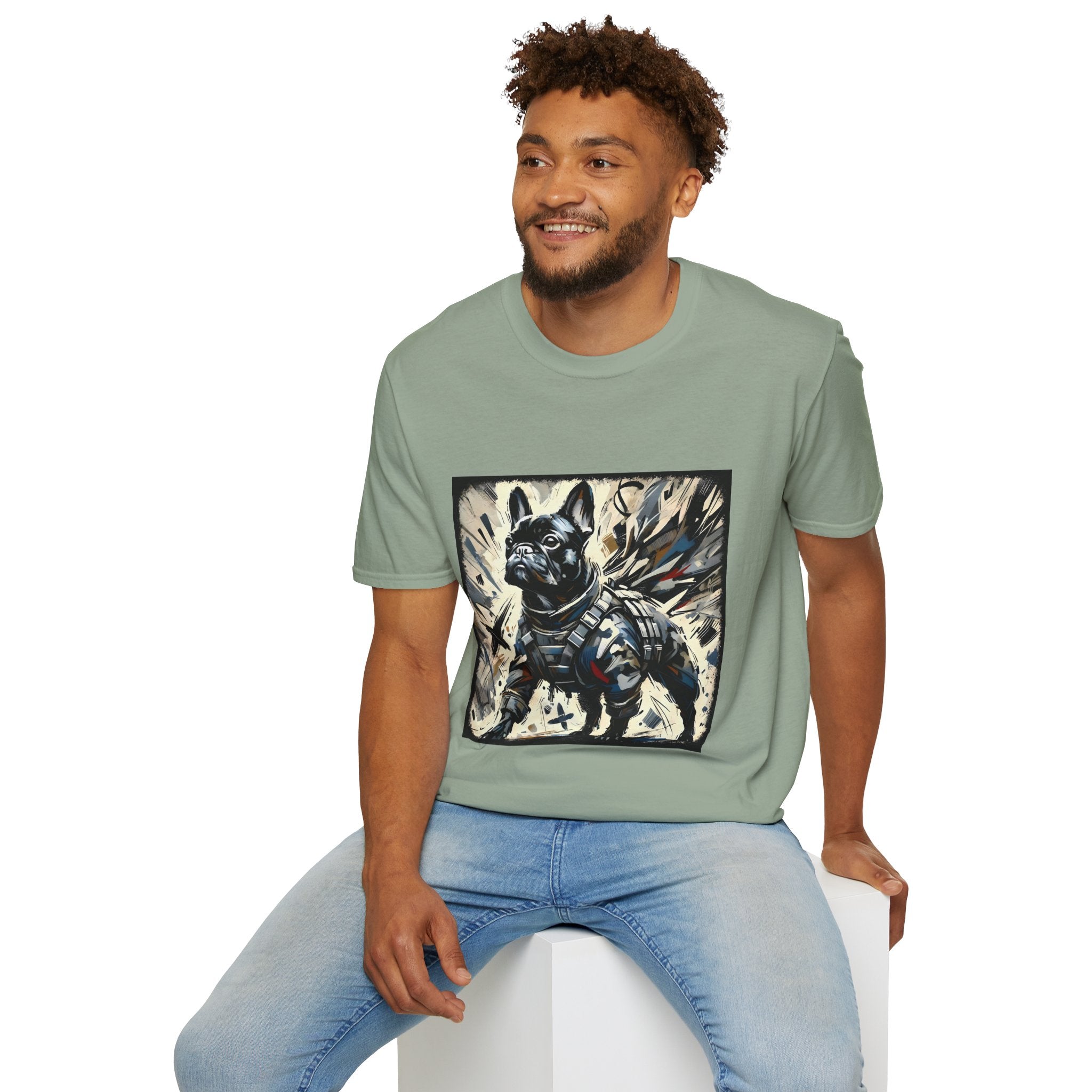 Male model in sage green dog t-shirt featuring heroic black French Bulldog in battle armor, set against abstract explosive strokes.