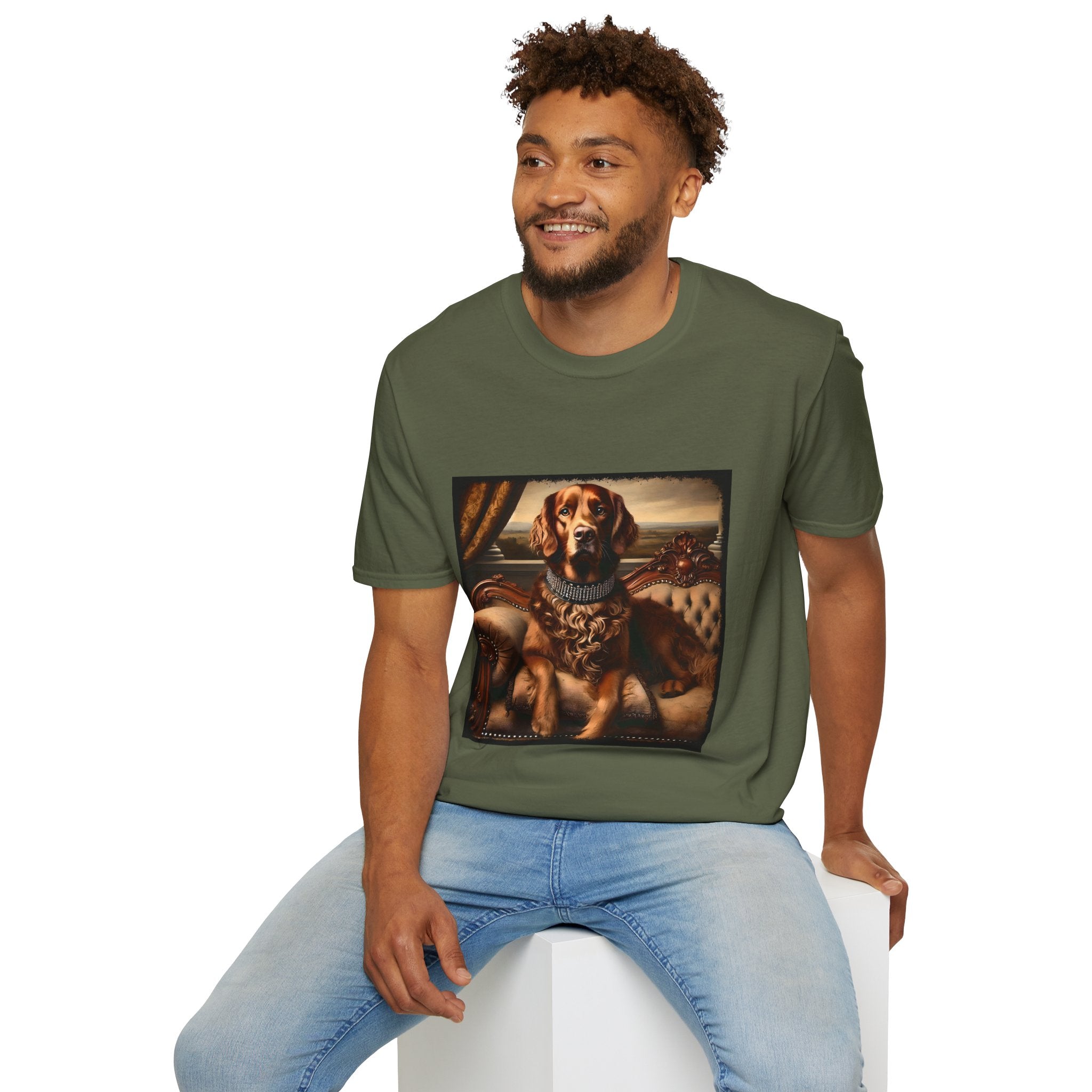 Male model wears military green dog t-shirt featuring a chocolate brown golden retriever in a jeweled collar, seated on a vintage tufted settee.