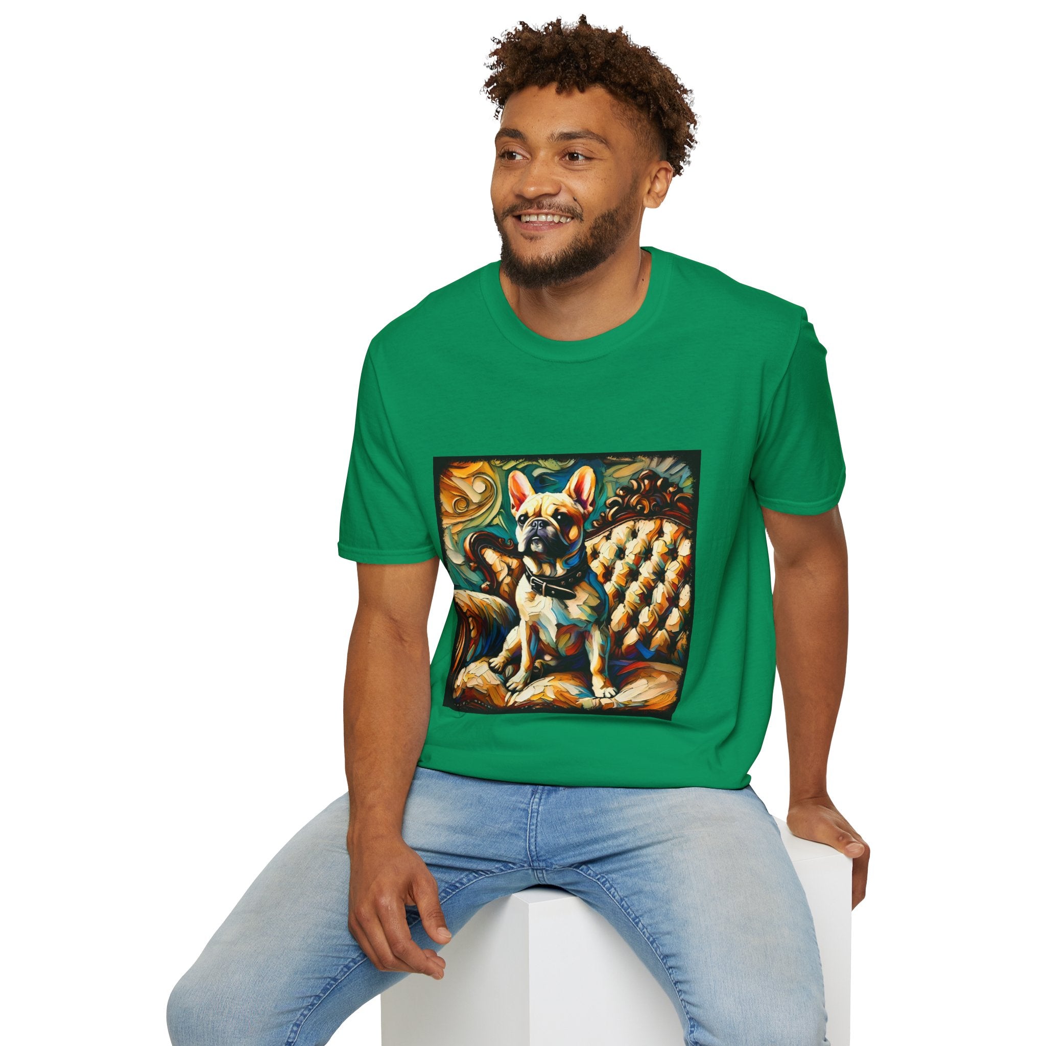 Smiling man in kelly green dog t-shirt featuring fawn French Bulldog with collar on golden tufted settee and bold swirl backdrop.