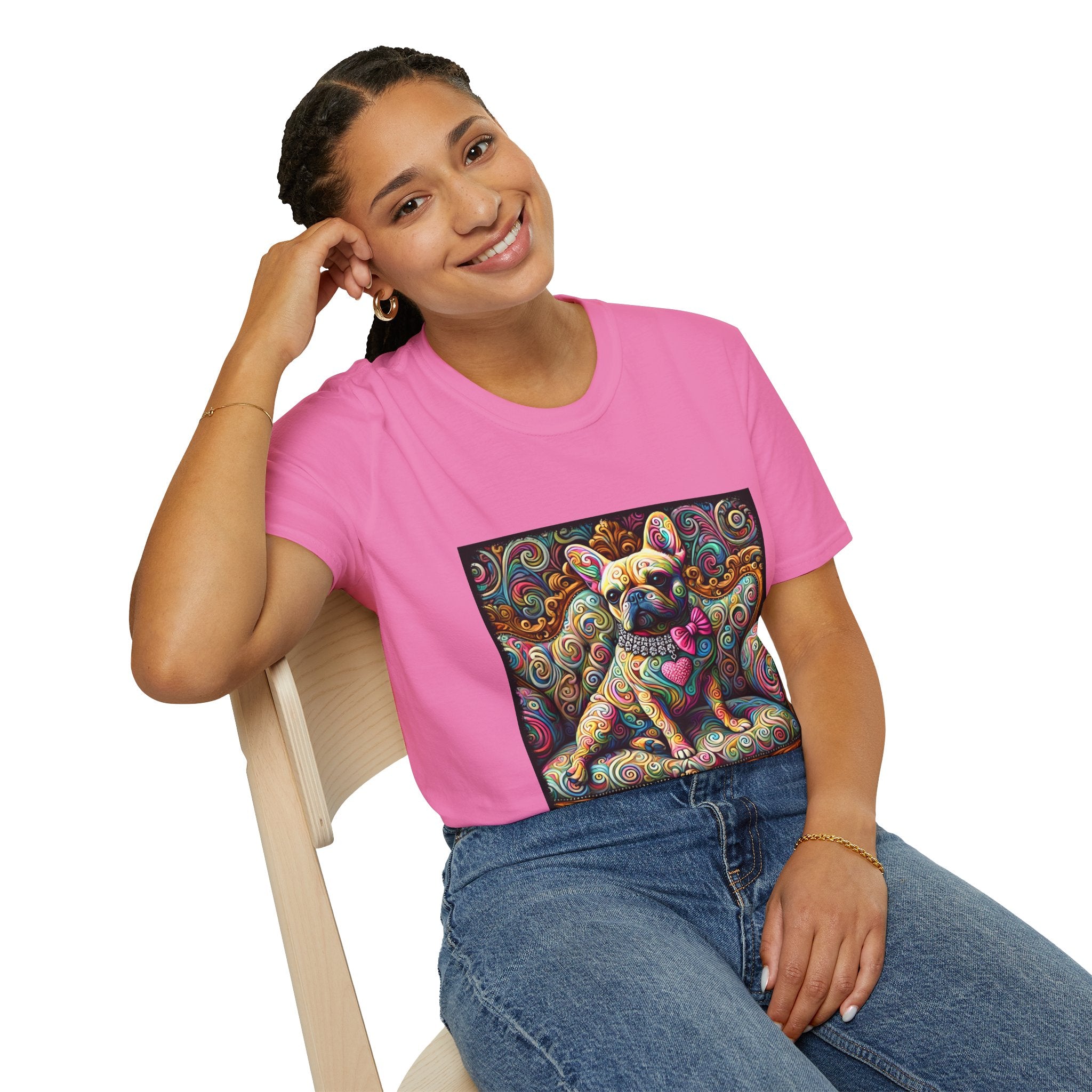 Female model in pink dog t-shirt featuring a tan French Bulldog with pink bow and heart on a vivid rainbow swirl couch.