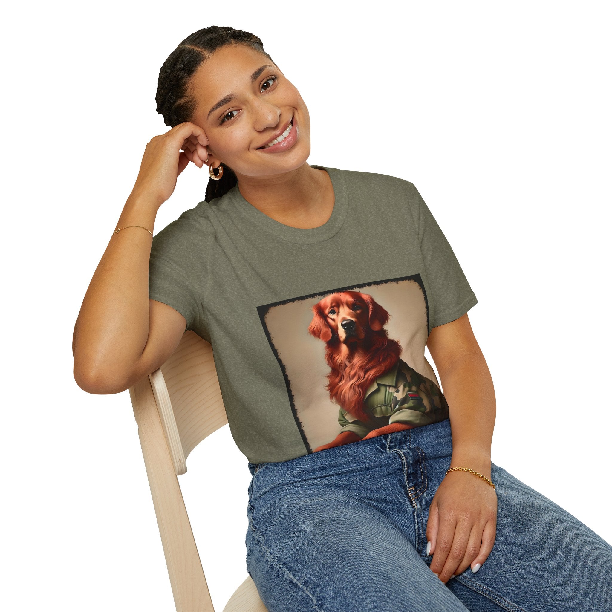 Female model in heather military green dog t-shirt featuring golden retriever in camouflage jacket with flag patch, tan background.